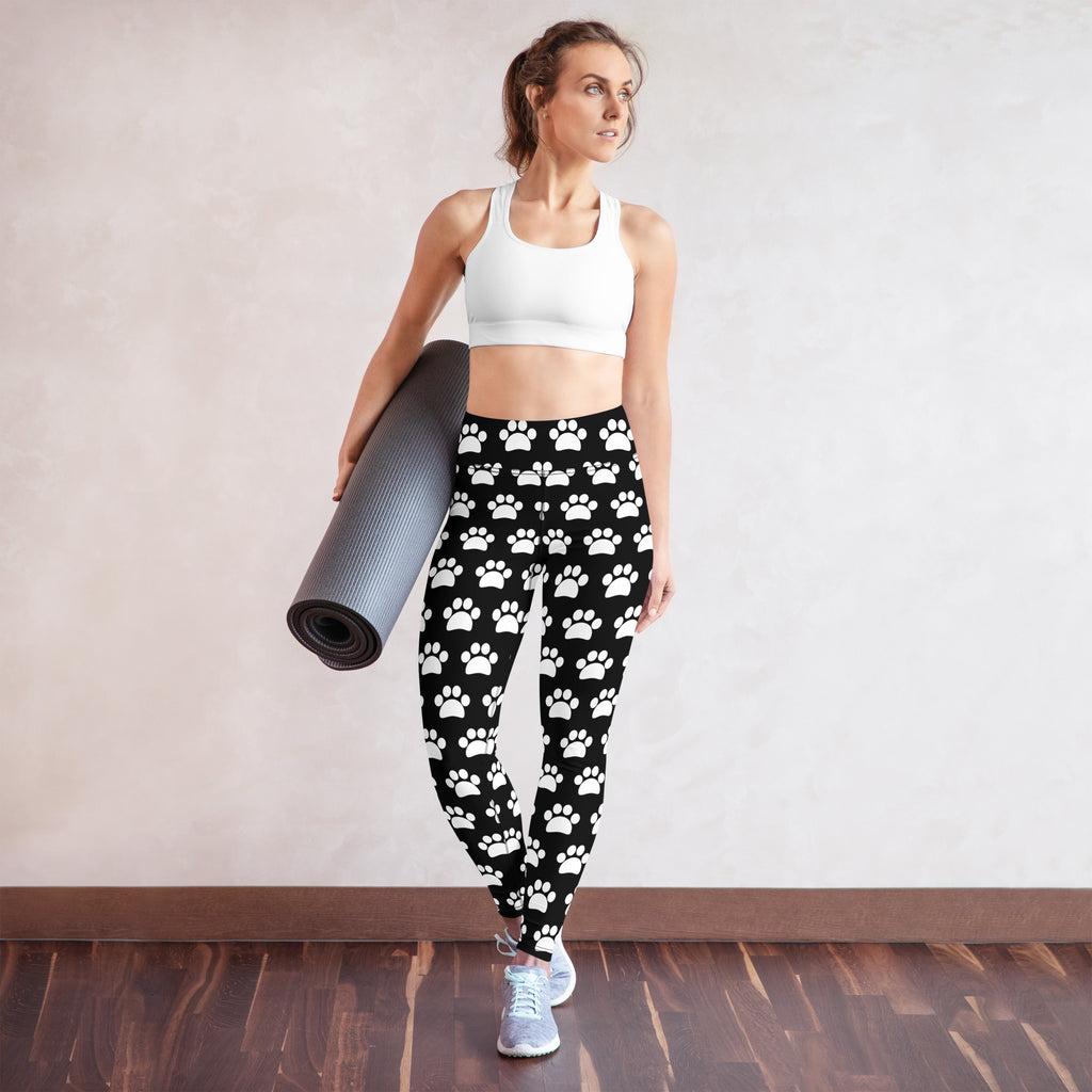 Women’s black buttery soft yoga leggings with white paw print pattern and comfortable stretch fabric
