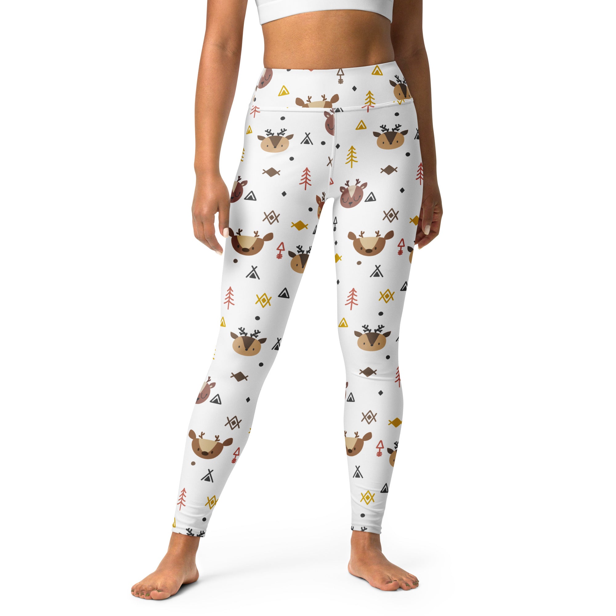 White buttery soft women’s yoga leggings with brown reindeer red and yellow trees fish and geometric shapes pattern
