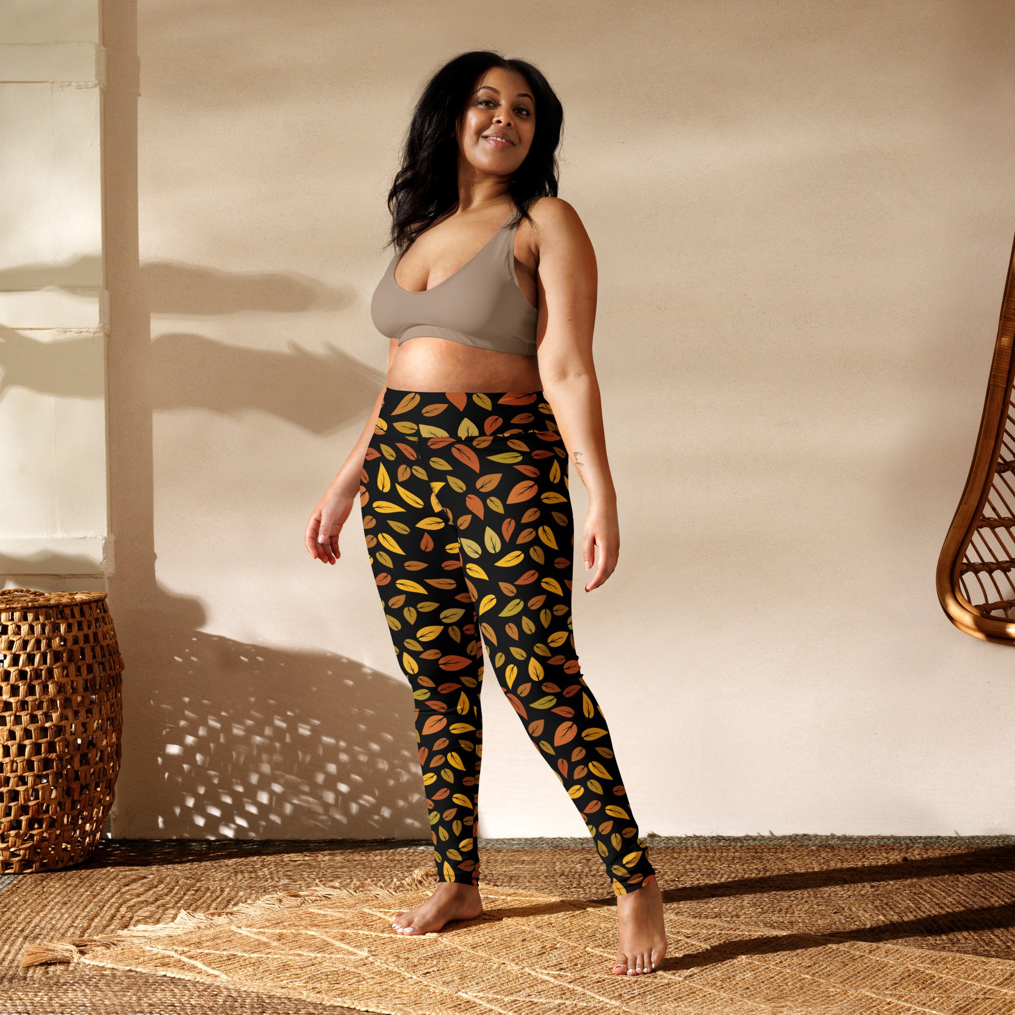 Women’s gold leaves buttery soft yoga leggings in black with a vibrant autumn leaf pattern in orange yellow and green