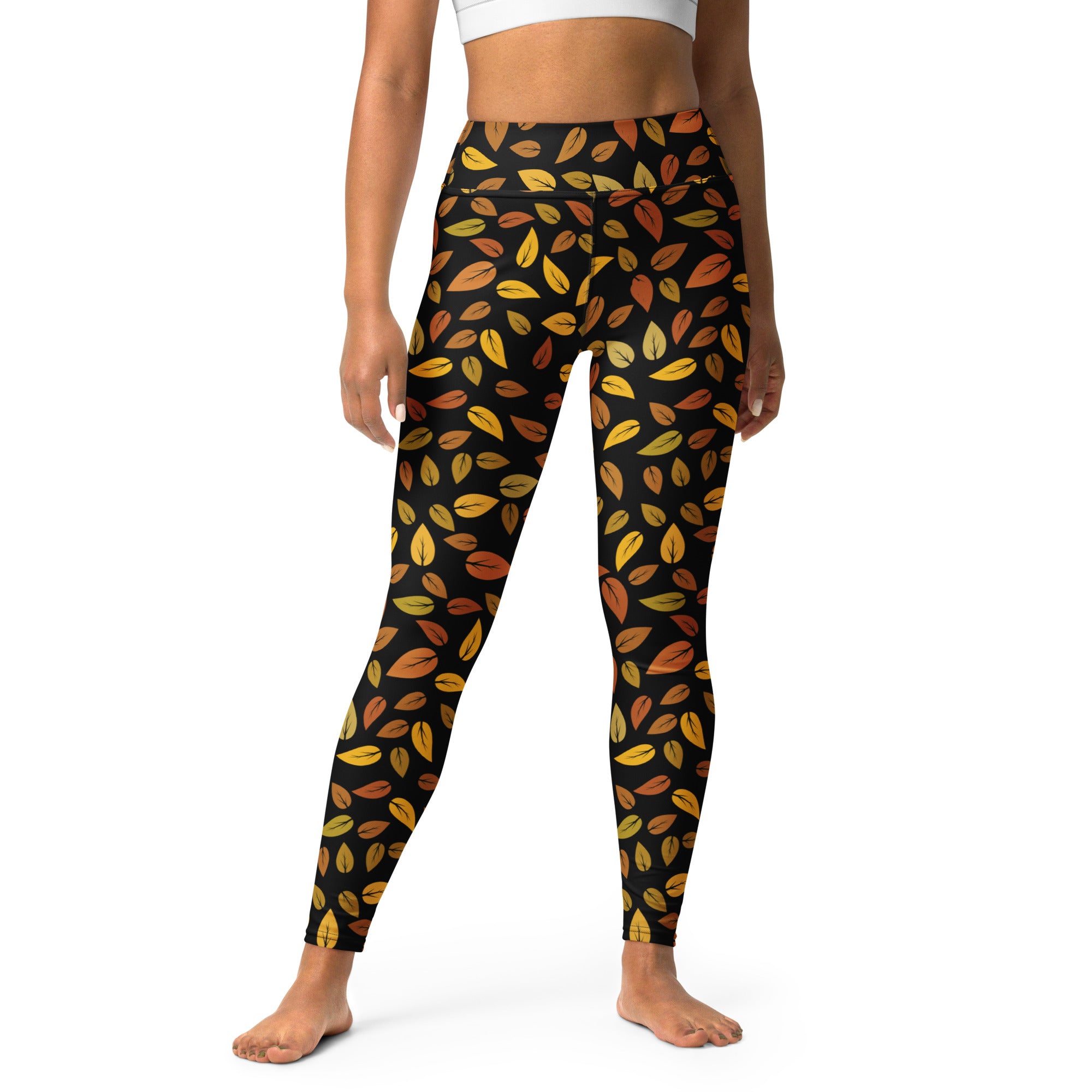 Women’s buttery soft black yoga leggings with vibrant gold yellow orange brown autumn leaf pattern