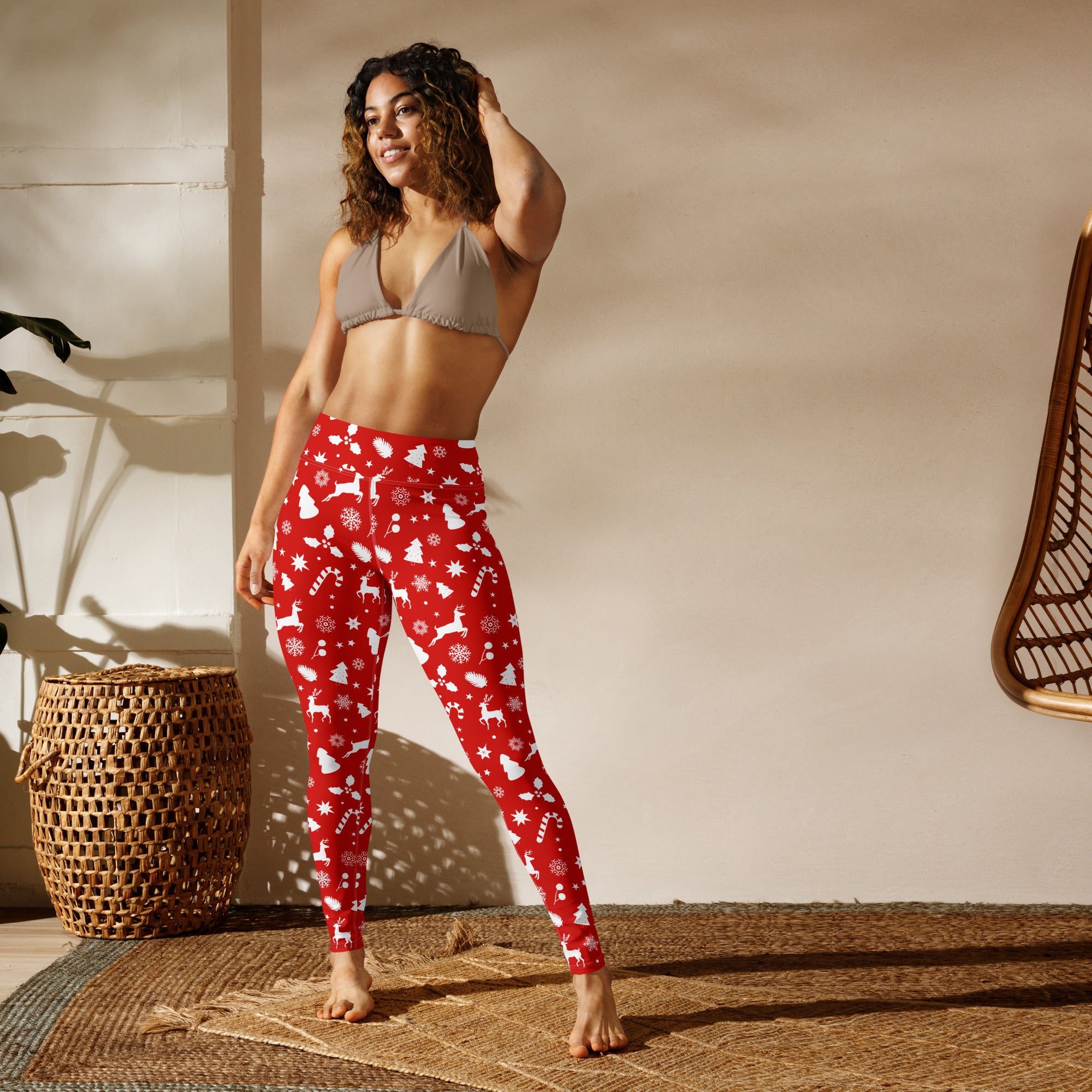Women’s red christmas buttery soft yoga leggings with white reindeer snowflakes and candy canes on stretchy fabric