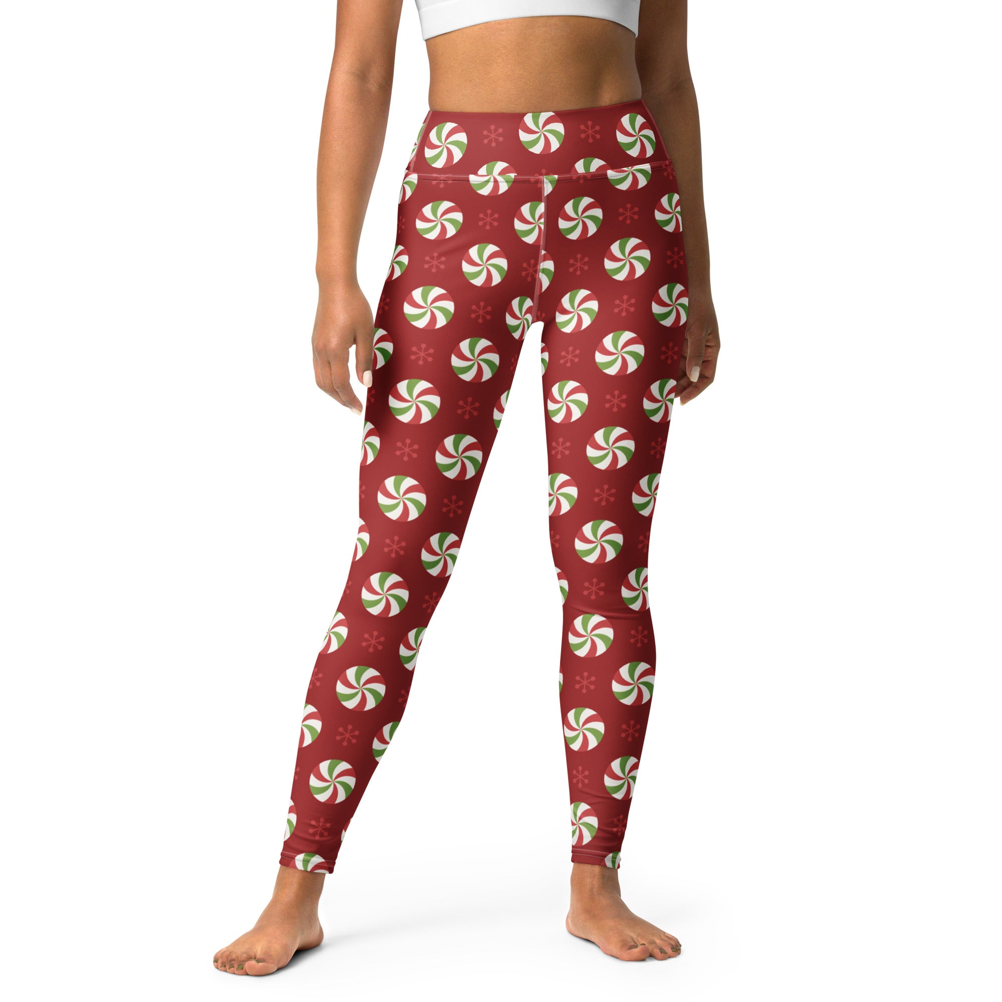 Red high-waisted buttery soft yoga leggings for women with a festive green and white peppermint candy pattern