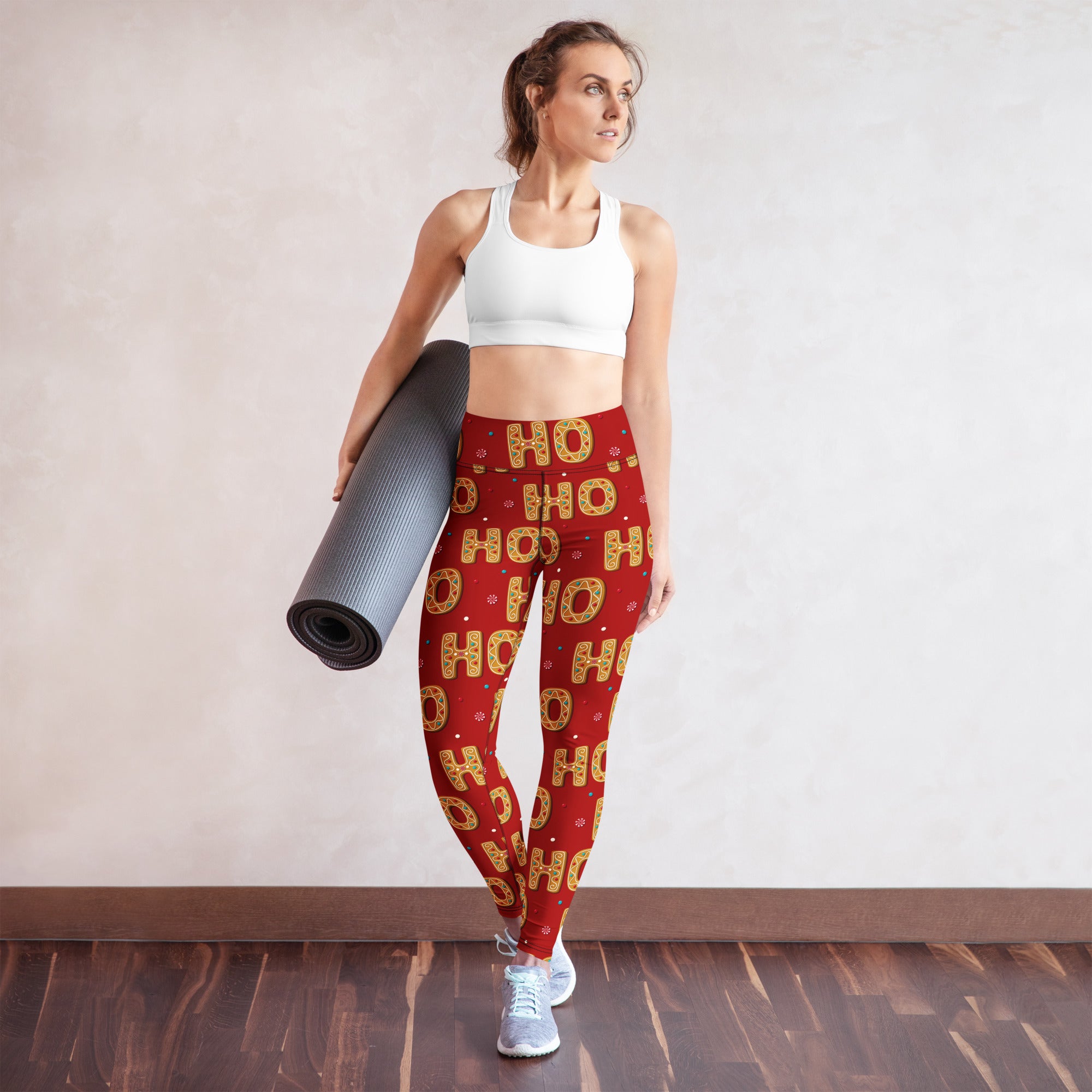 Women’s red buttery soft yoga leggings with festive gold ho ho ho lettering and small snowflake accents for christmas