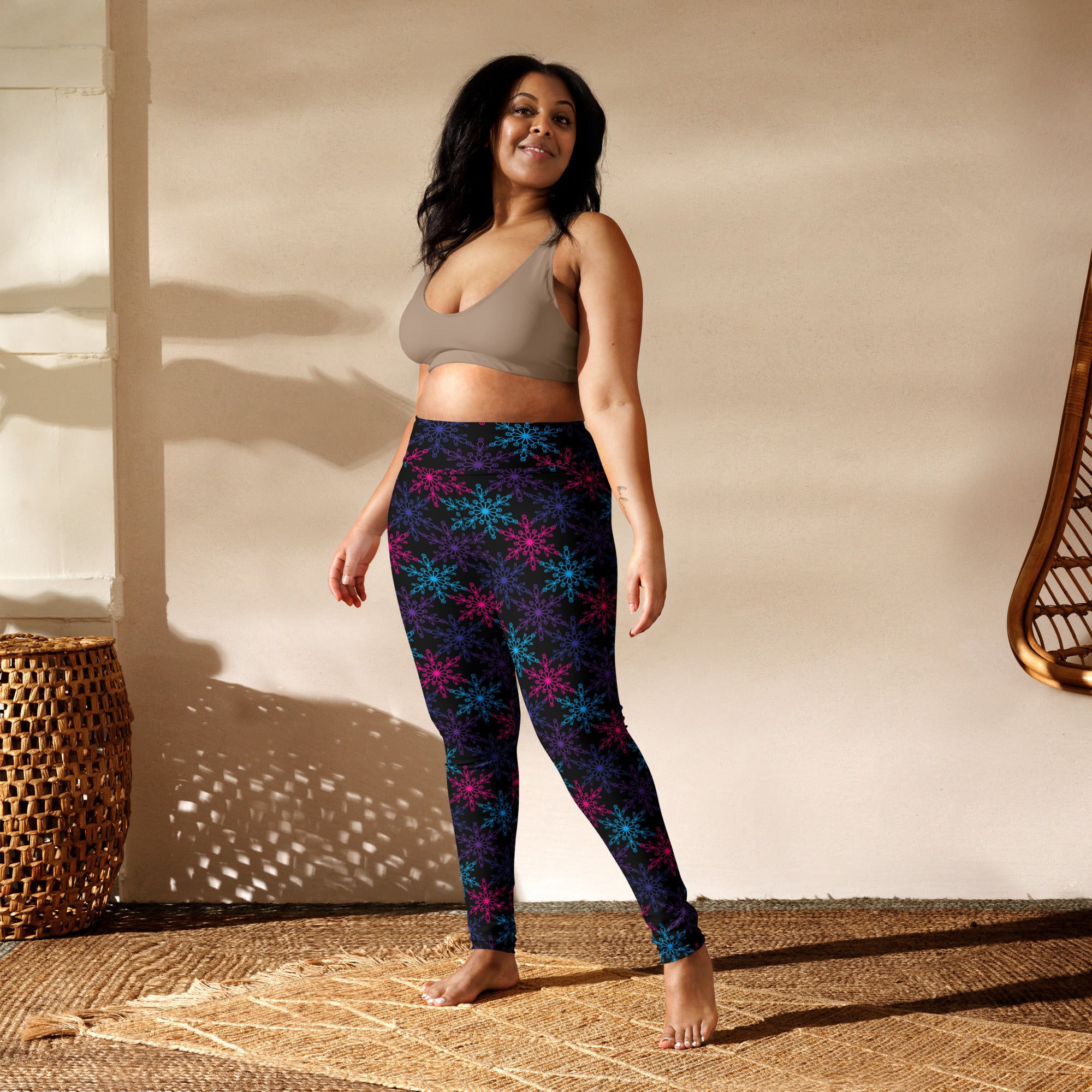 Dark blue women’s neon snowflake winter buttery soft yoga leggings with glowing turquoise and magenta snowflake pattern