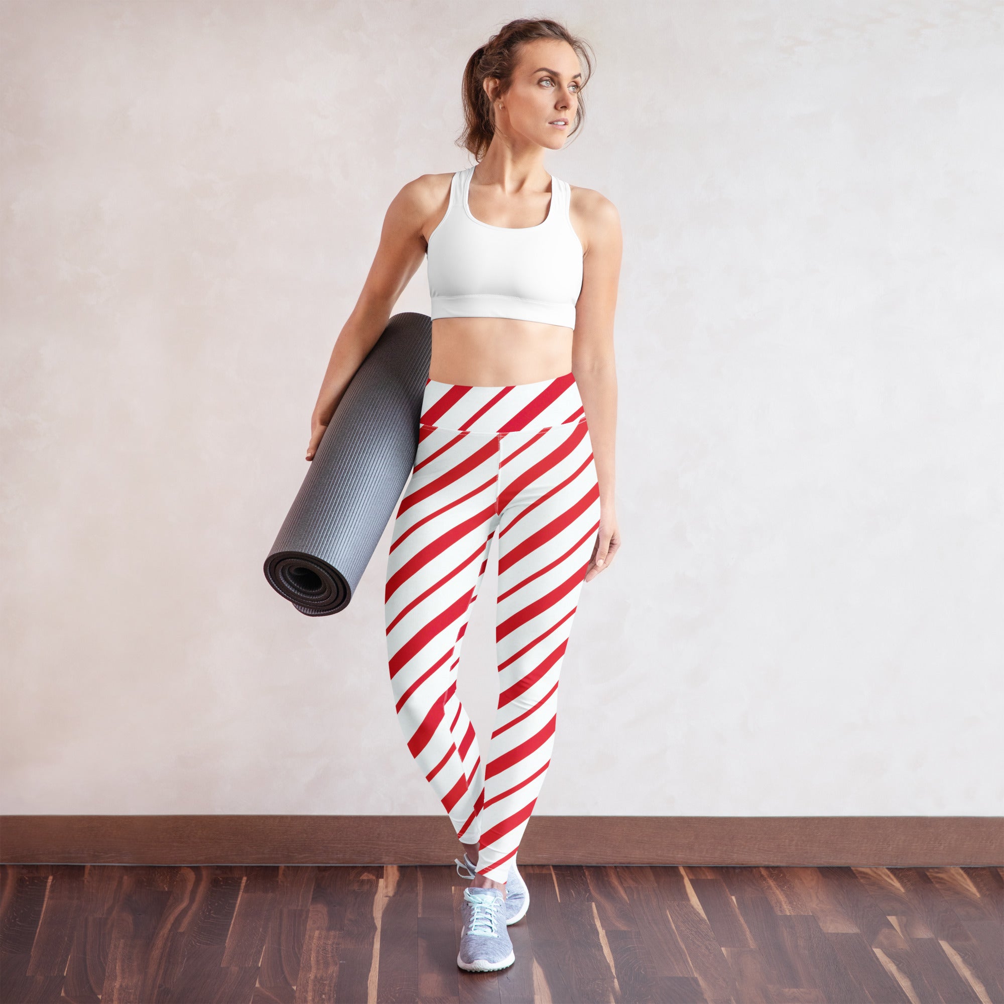 Women’s buttery soft yoga leggings with red and white candy cane diagonal stripes for festive activewear