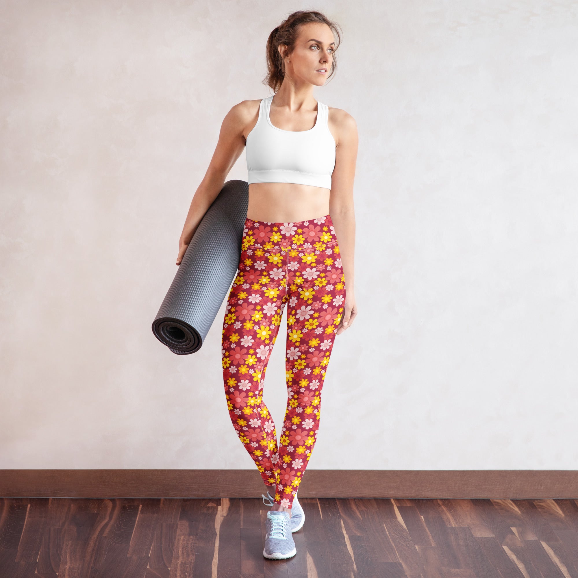 Woman wearing women’s red floral buttery soft yoga leggings with yellow flower pattern front view