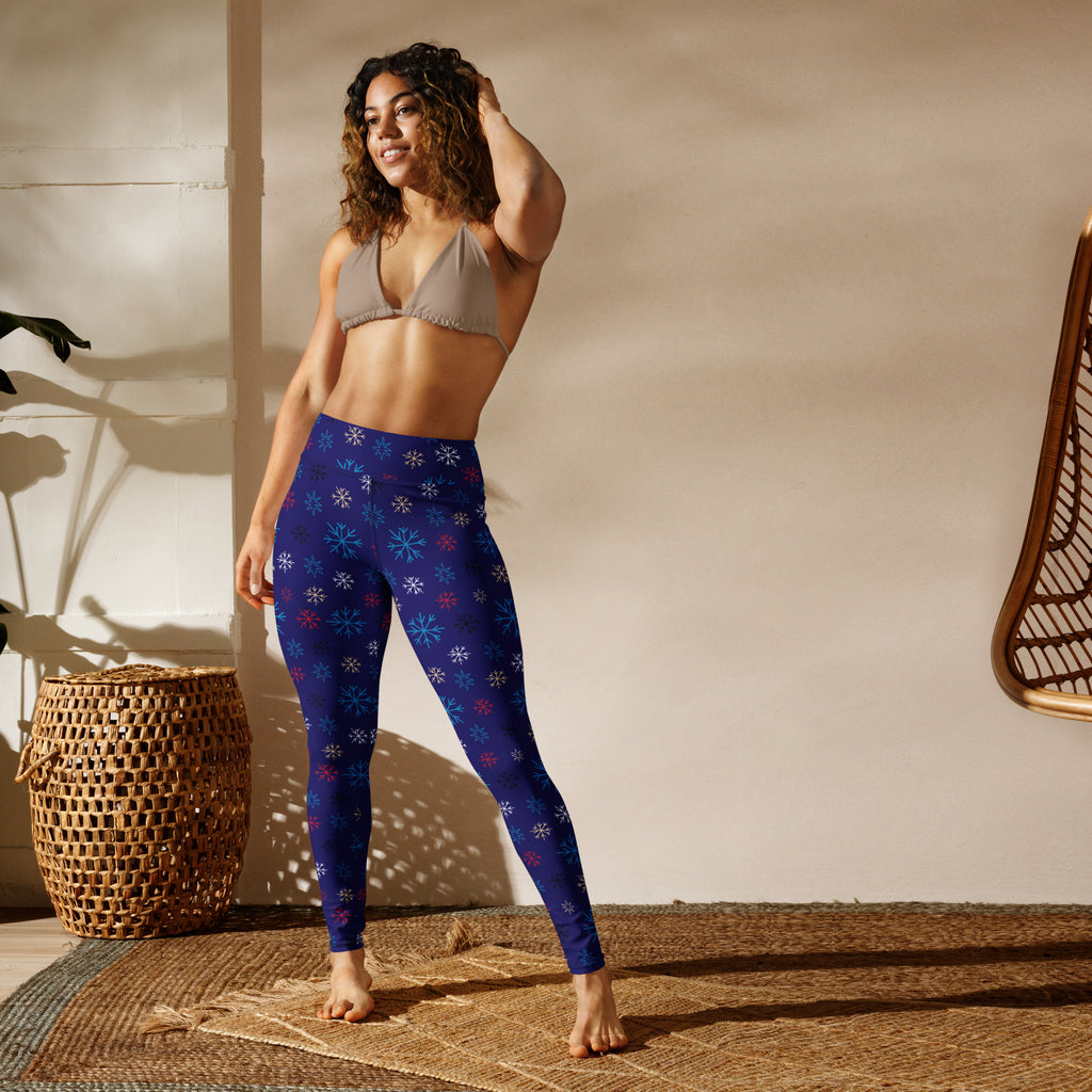 Women’s navy yoga leggings with buttery soft fabric and multicolored snowflake pattern
