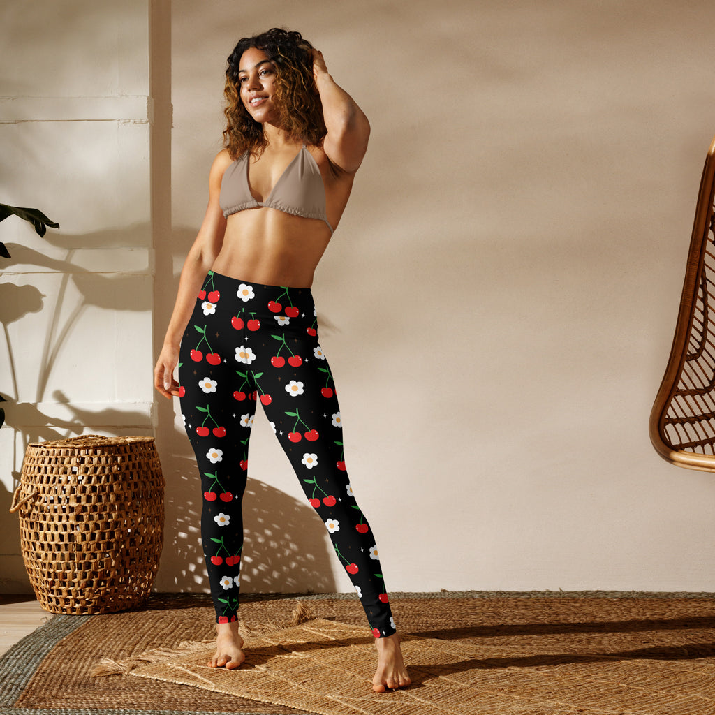 Women’s black buttery soft yoga leggings with a playful red cherry and white flower pattern