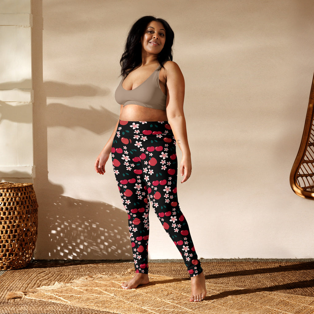 Women’s black buttery soft yoga leggings with vibrant red cherries and pink blossoms pattern
