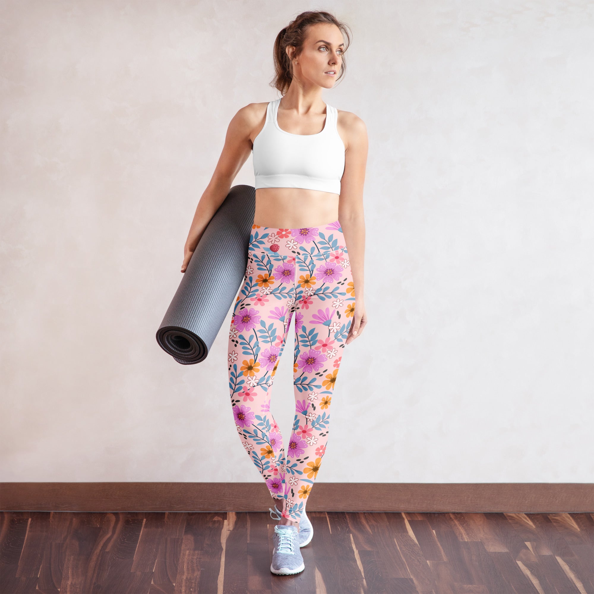 Women’s pink floral buttery soft yoga leggings with vibrant purple orange and blue flower and leaf pattern