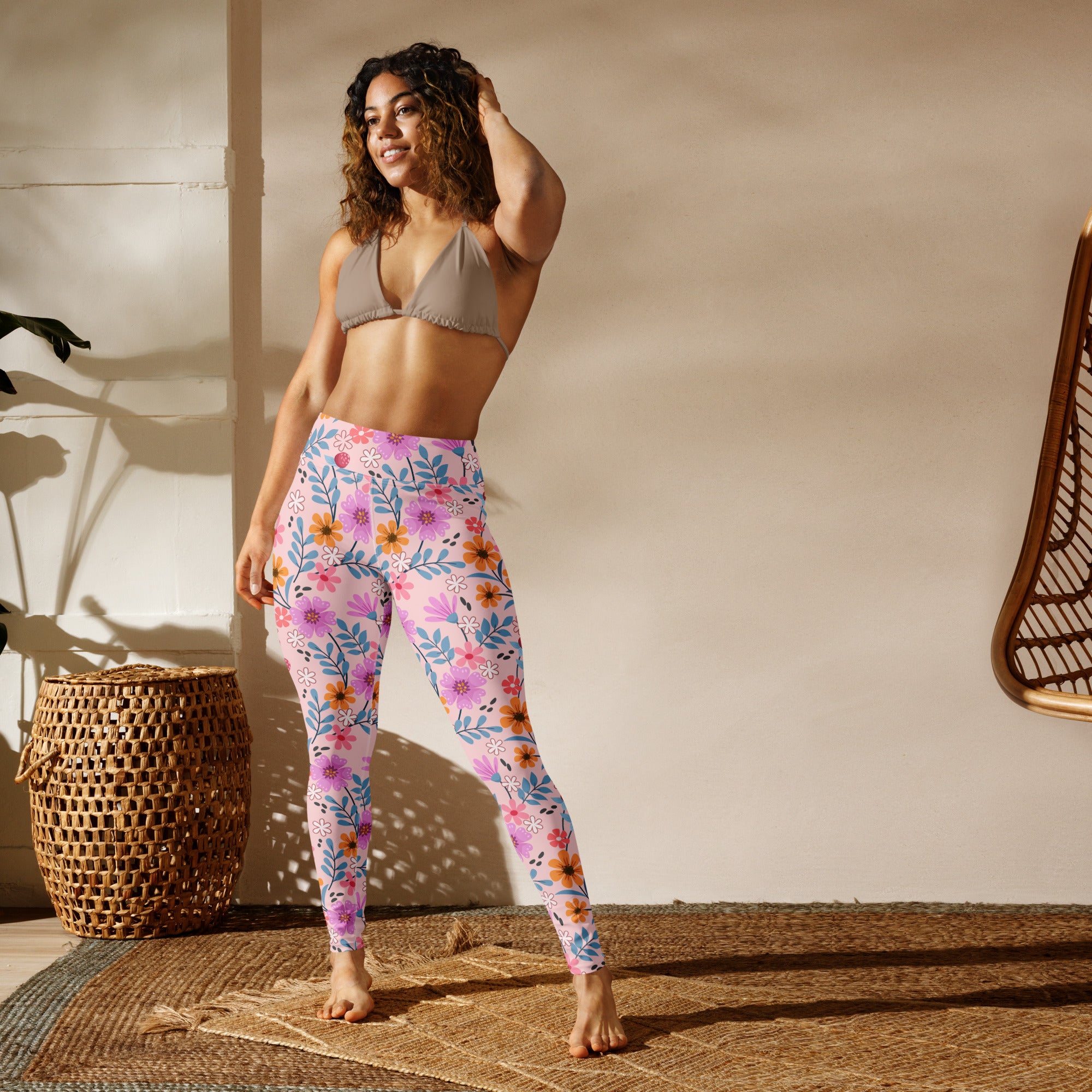 Women’s pink floral buttery soft yoga leggings with vibrant purple, orange, and blue flower pattern on light pink background