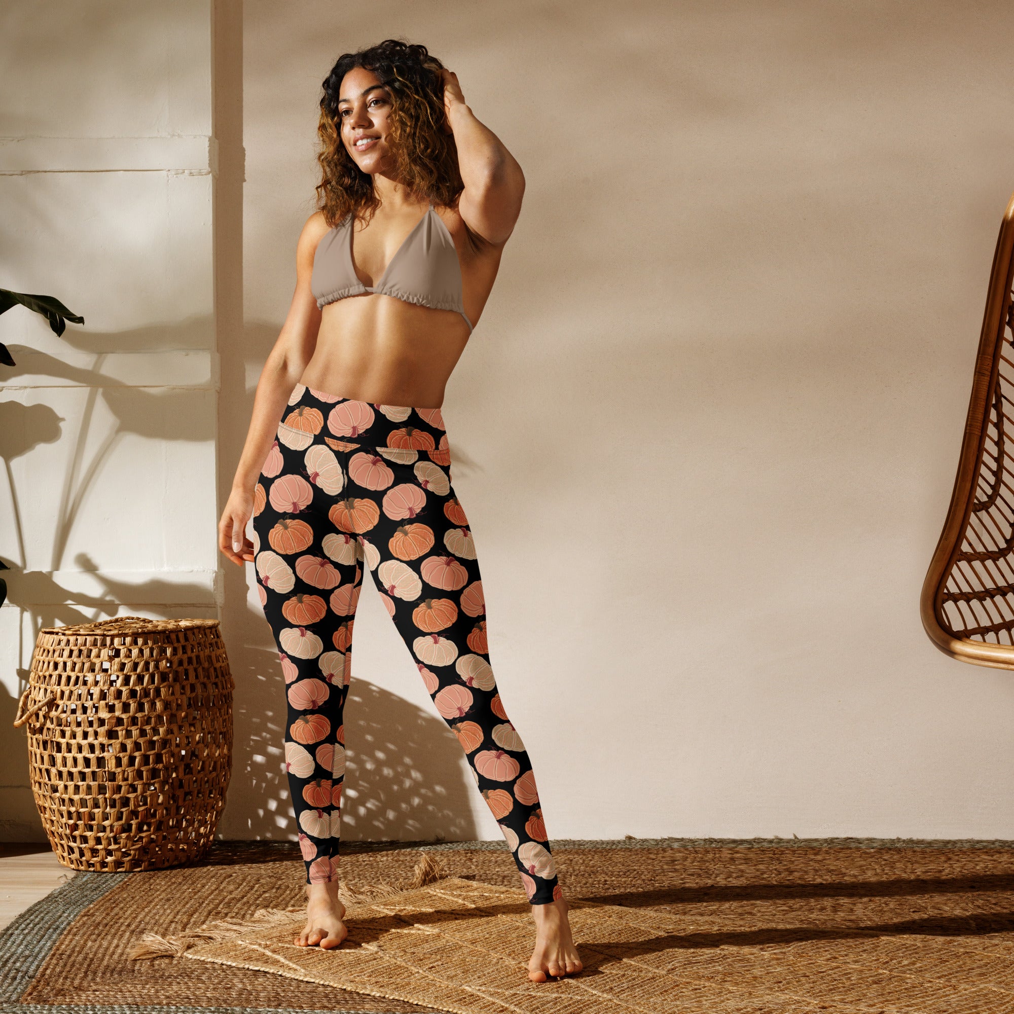 Black buttery soft women’s yoga leggings with a playful orange and beige pumpkin pattern for fall workouts