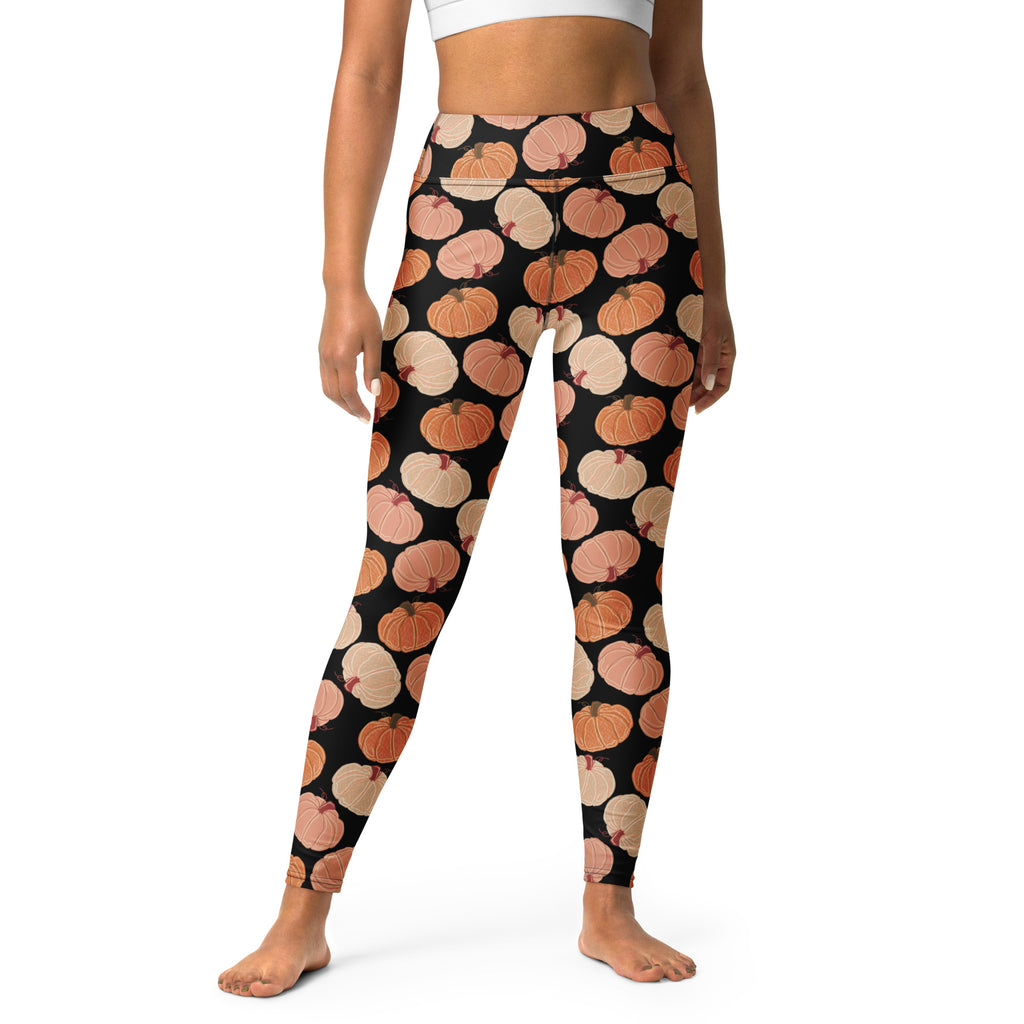 Women’s pumpkin patch buttery soft yoga leggings in black with a repeating orange and beige pumpkin pattern