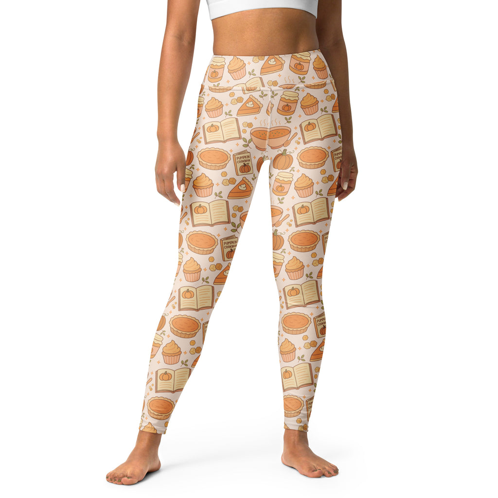 Cream-colored buttery soft women’s yoga leggings with pumpkin pie cupcake and autumn book patterns