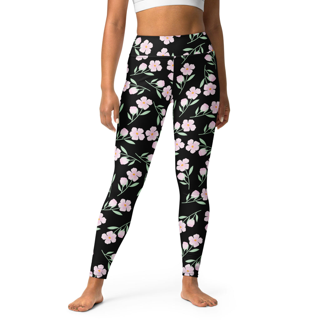 Women’s black floral buttery soft yoga leggings with pink flower and green stem pattern on black fabric
