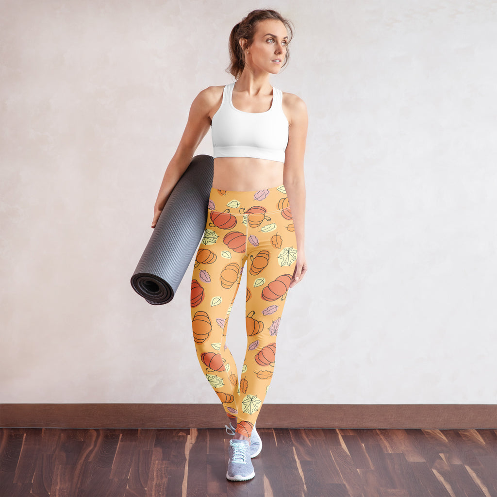 Yellow buttery soft women’s yoga leggings with playful orange pumpkins and multicolored leaves fall pattern