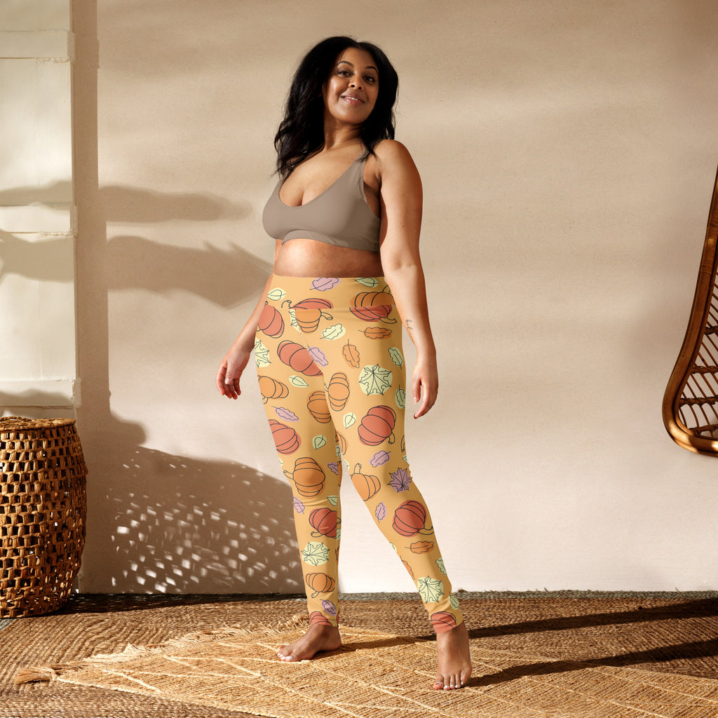Women’s yellow buttery soft yoga leggings with orange pumpkins and pastel leaves pattern for fall pumpkin season