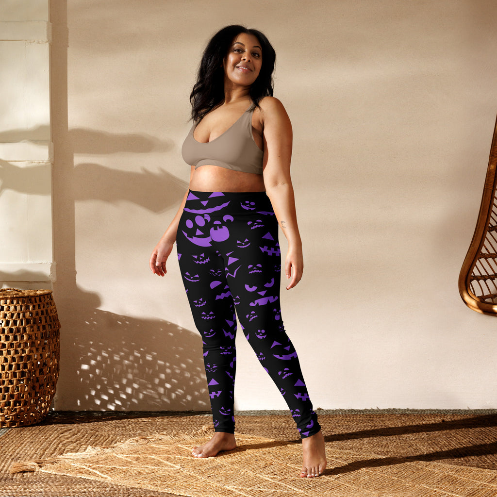 Women’s purple jack-o-lantern faces halloween buttery soft yoga leggings with vibrant spooky pattern on black fabric