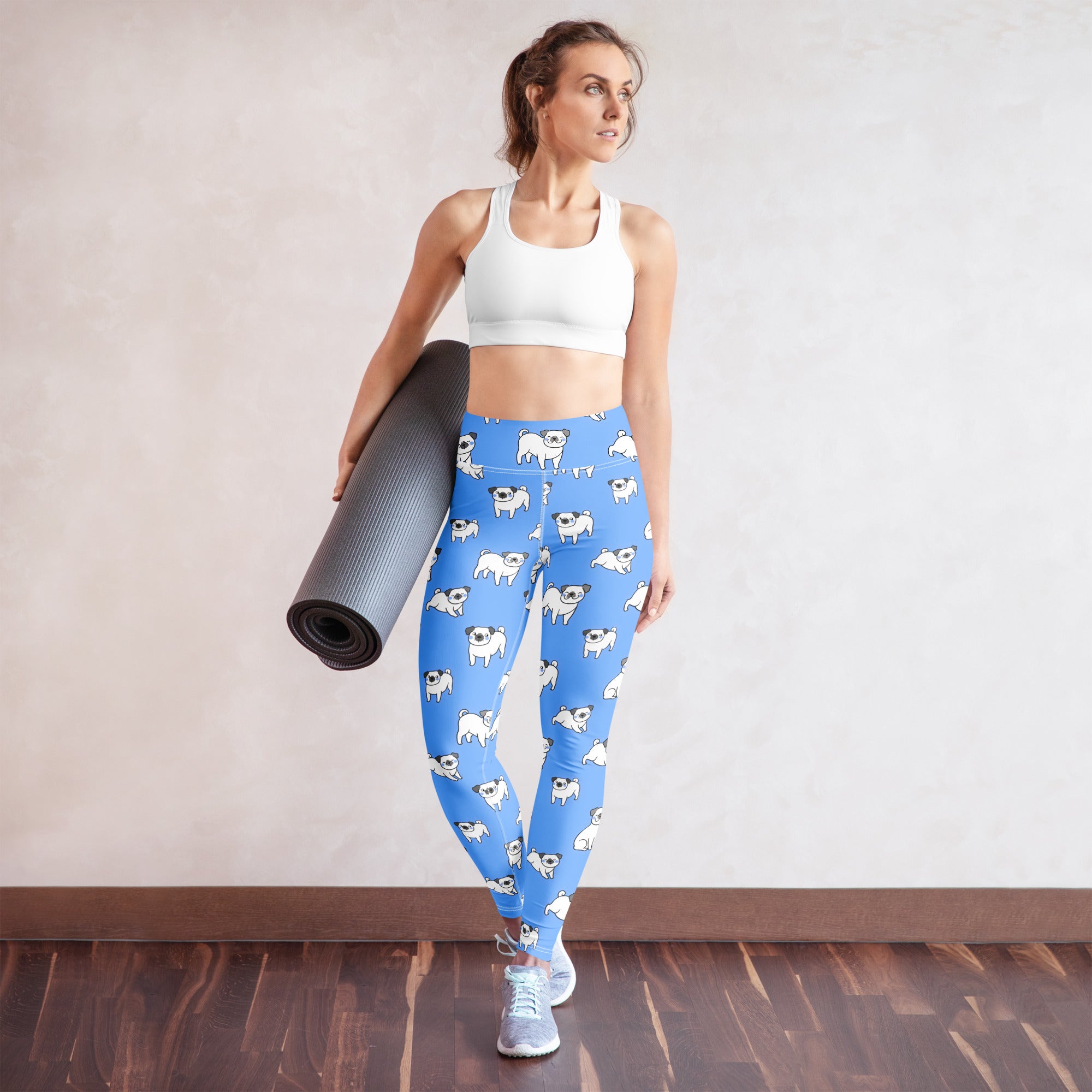 Women’s blue buttery soft yoga leggings with a repeating white pug illustration pattern