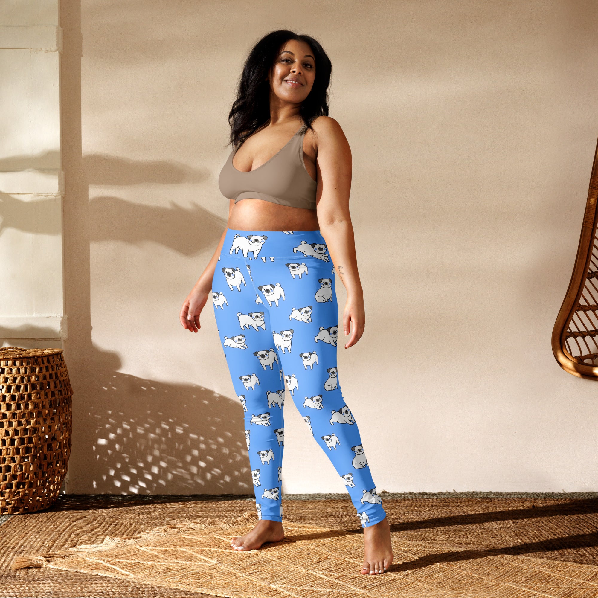 Women’s blue buttery soft yoga leggings with a repeating pattern of white pug illustrations