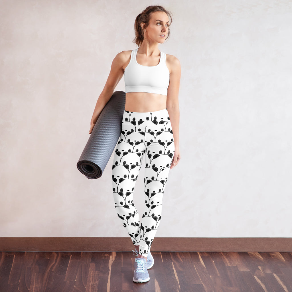 White high-waisted buttery soft yoga leggings with black panda face and leaf pattern for women