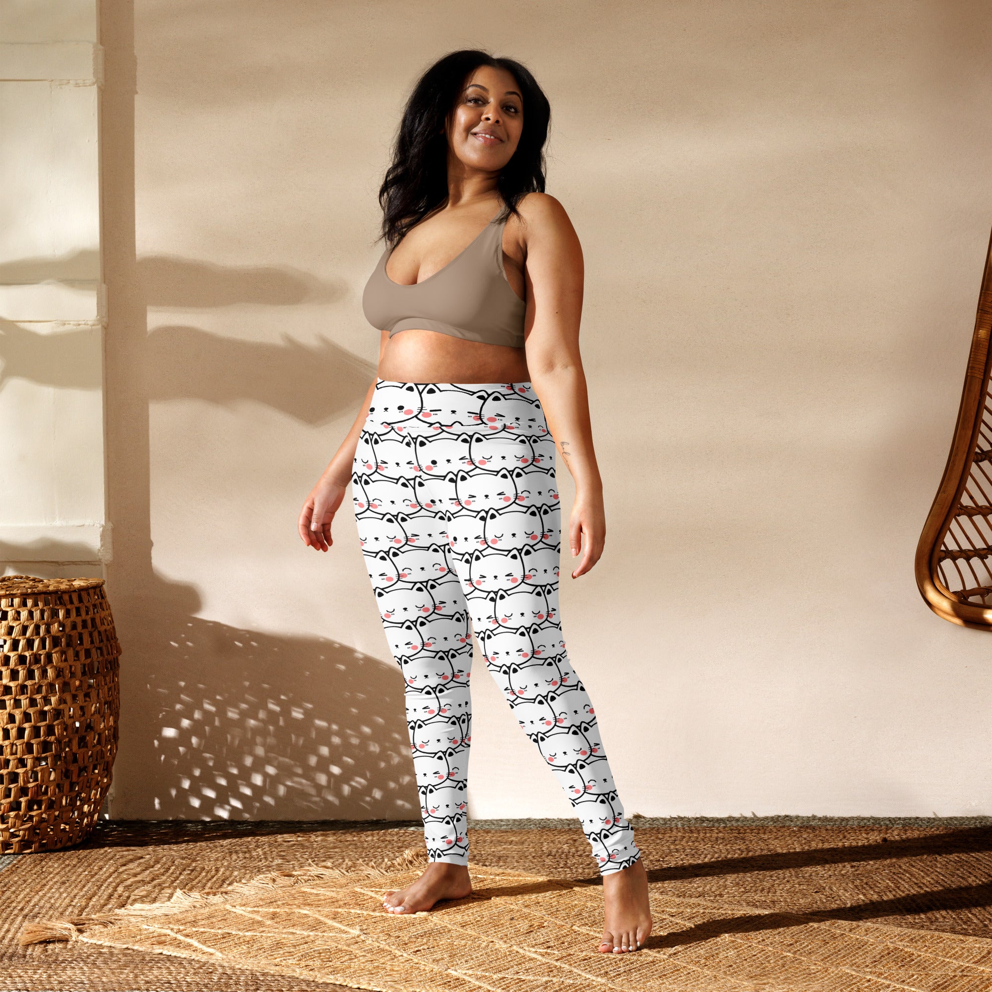 White women’s buttery soft yoga leggings with black and pink cartoon cat face print pattern