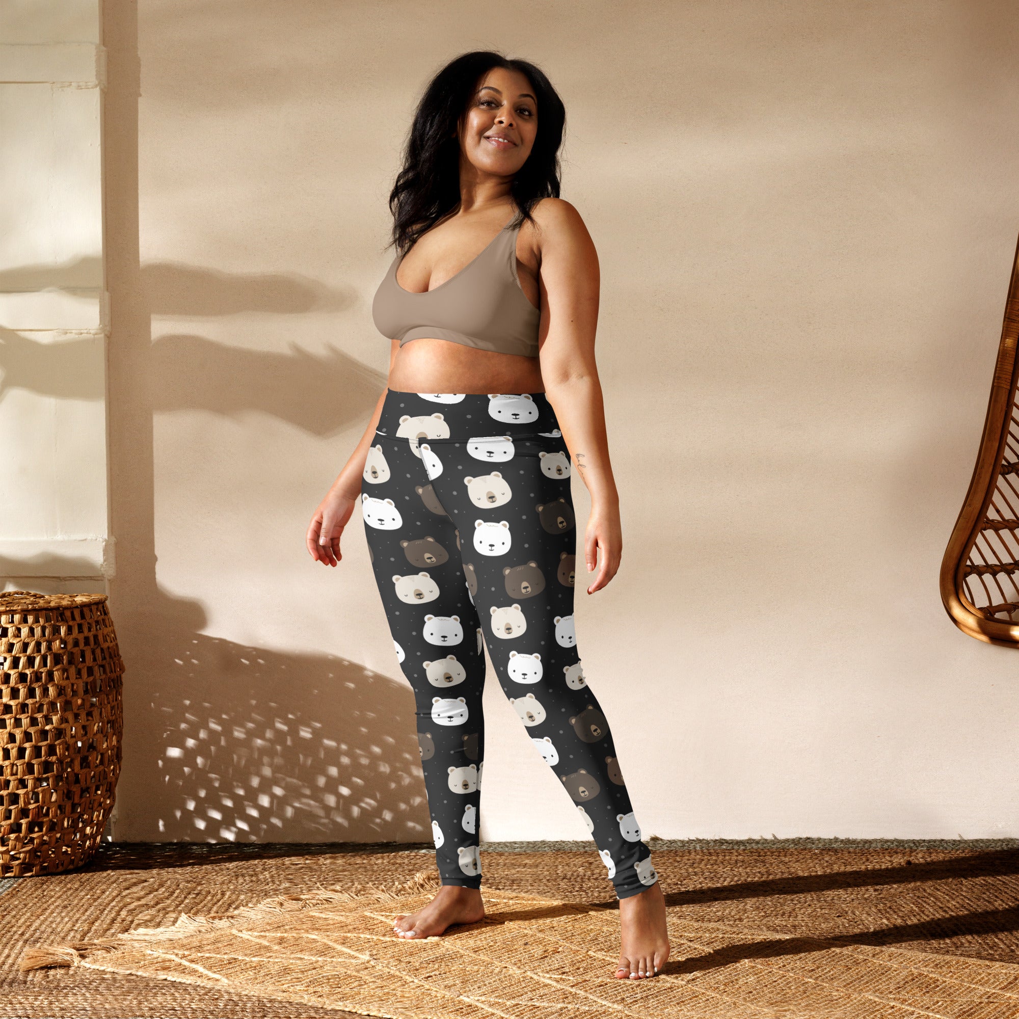 Women’s black buttery soft yoga leggings with playful white and brown bear face pattern