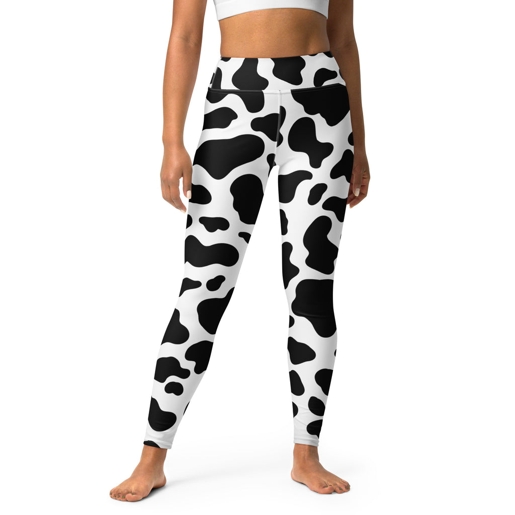 Women’s high-waisted buttery soft black and white cow print yoga leggings shown from the back side