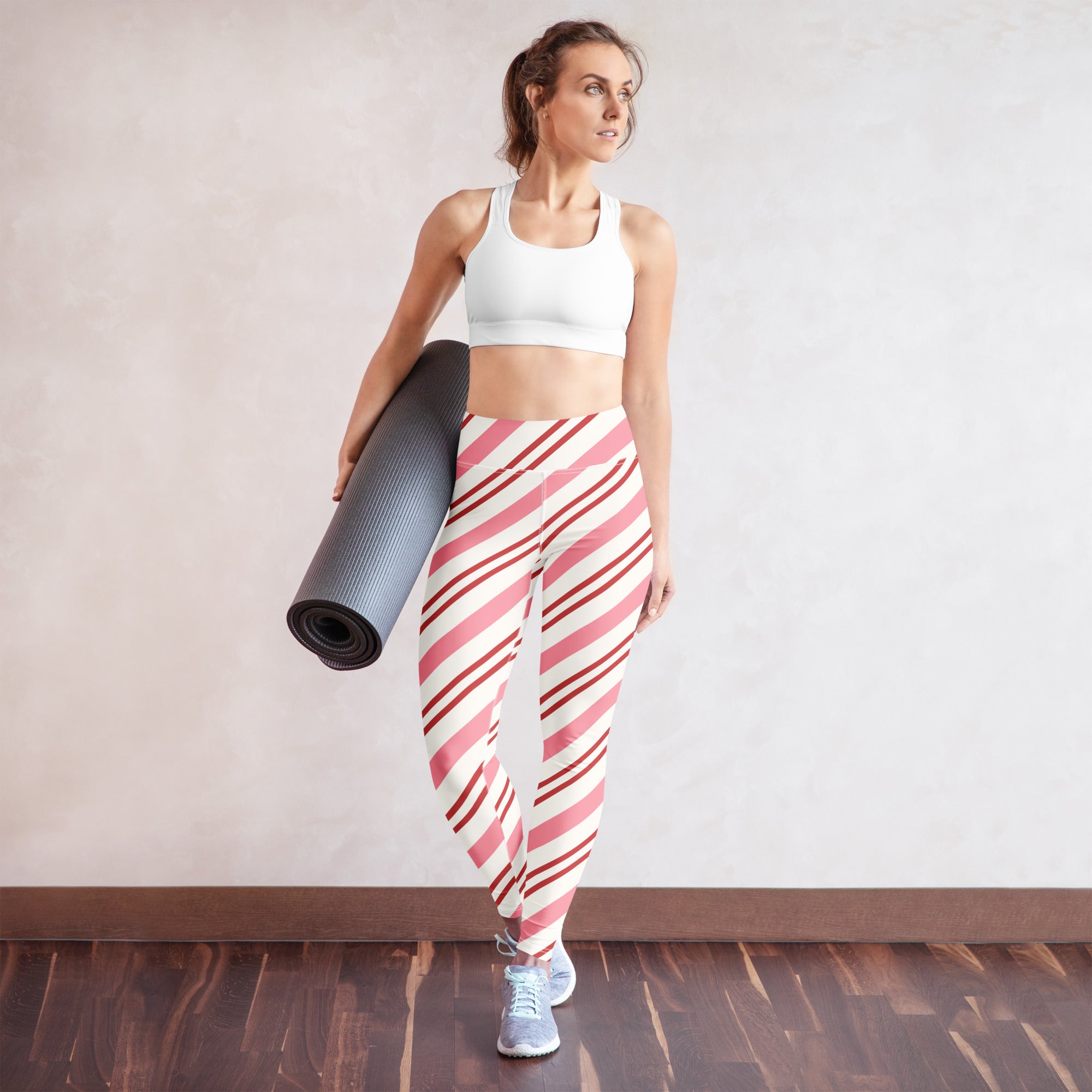 Women’s buttery soft yoga leggings with pink and white candy cane stripe pattern in diagonal design