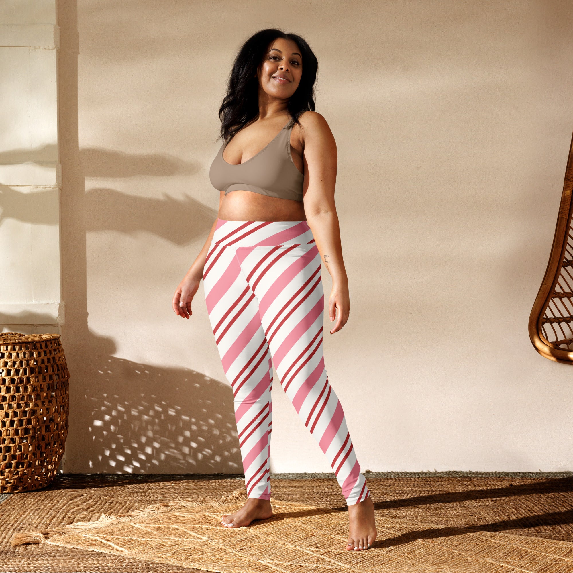 Women’s buttery soft yoga leggings with pink and white candy cane diagonal stripes visible from the front