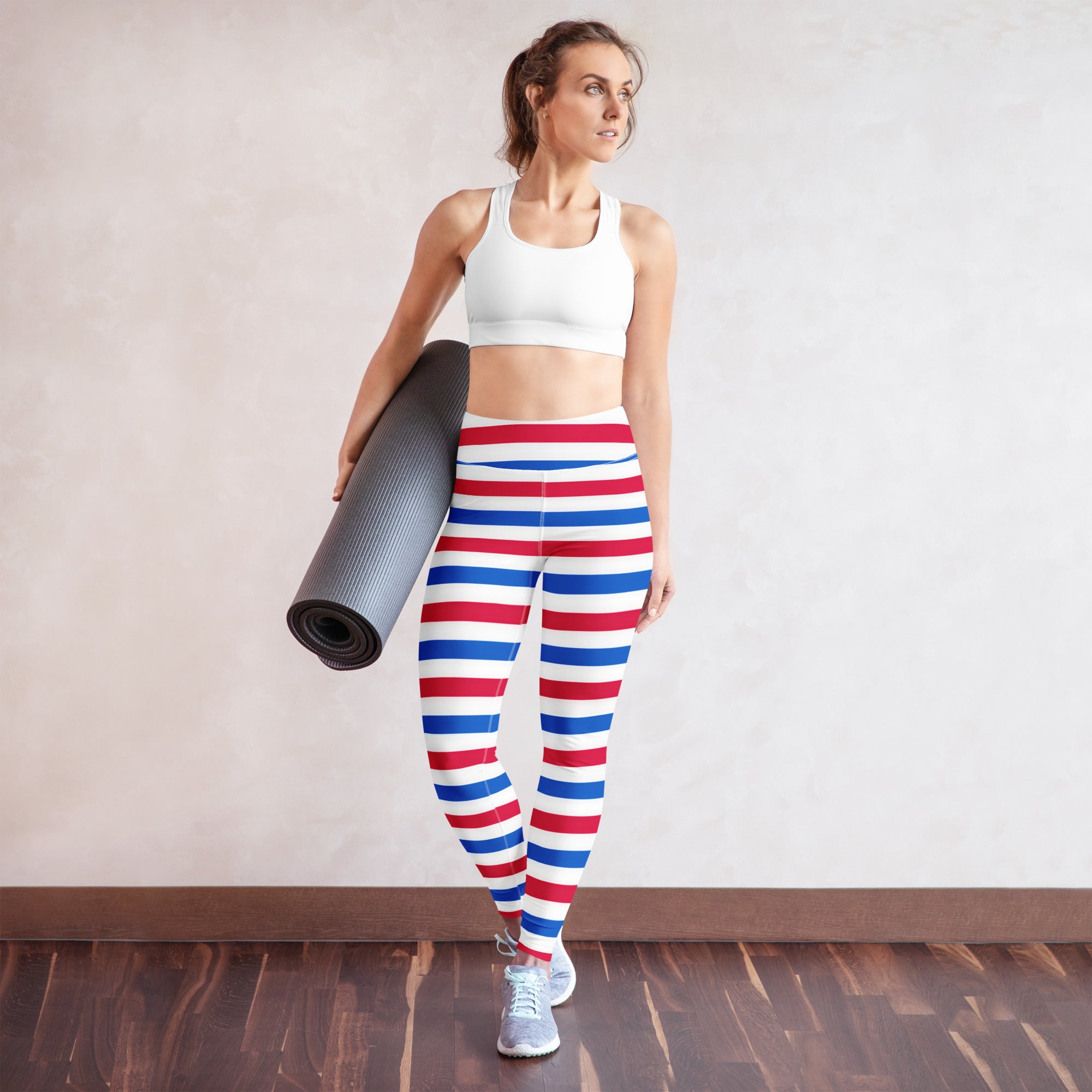 Women’s striped 4th of july buttery soft yoga leggings in red white and blue horizontal stripes worn by a woman
