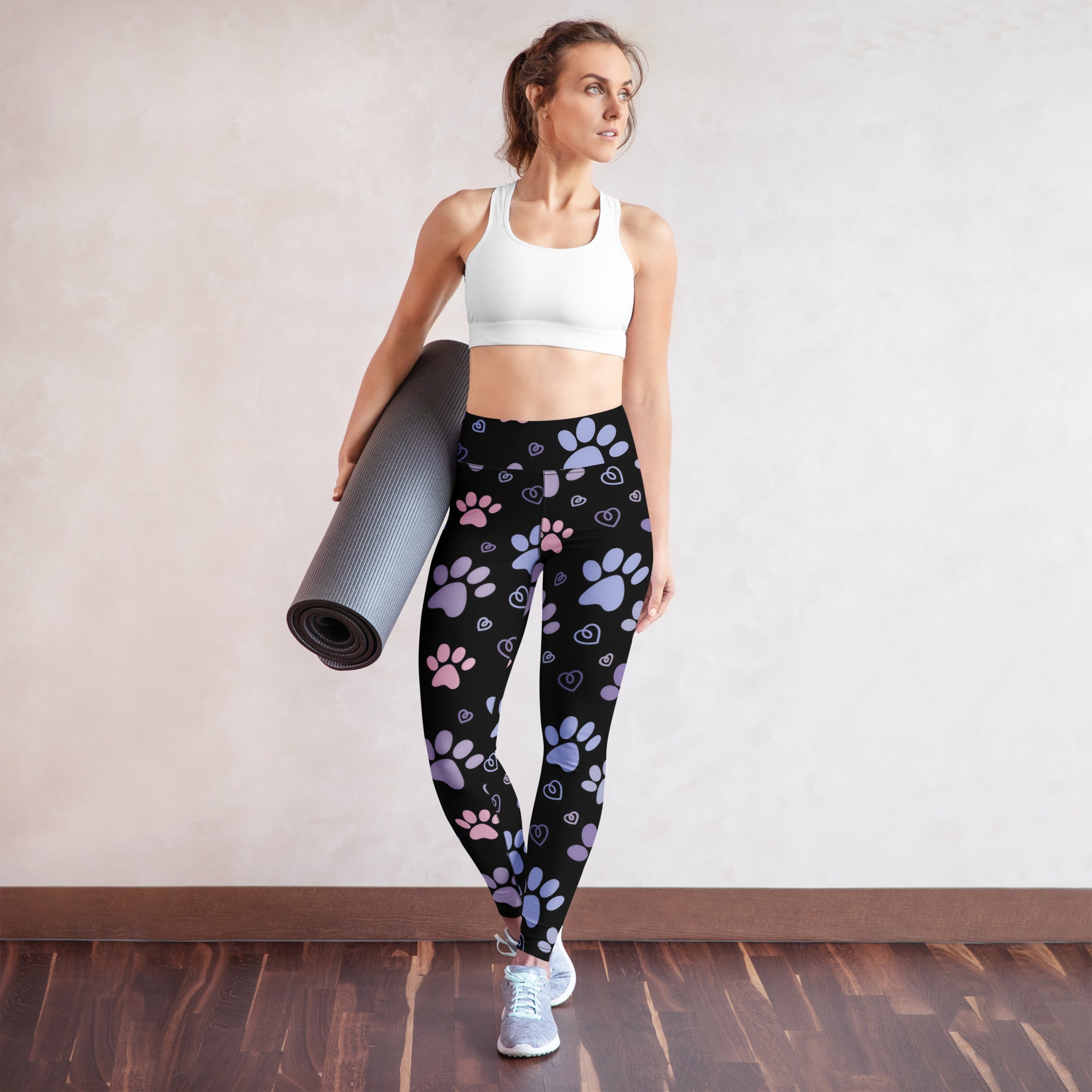 Black buttery soft women’s yoga leggings with pink and purple pastel paw prints and heart patterns