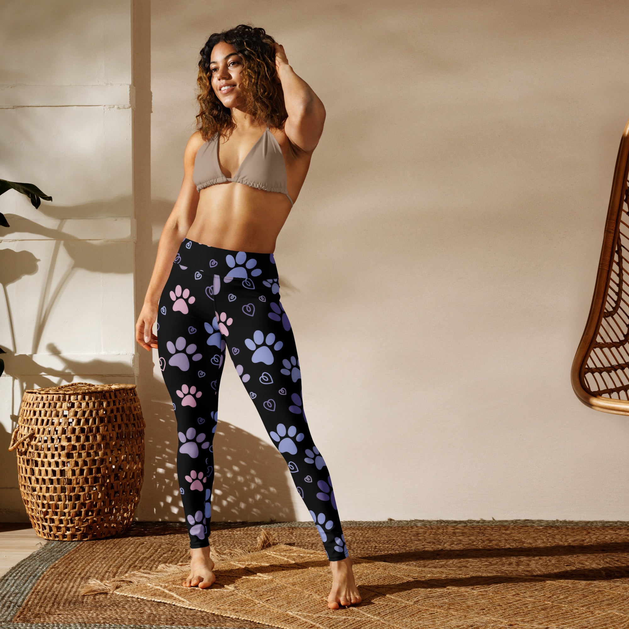Black women’s pastel paw print buttery soft yoga leggings with pink and purple paw prints and small hearts pattern