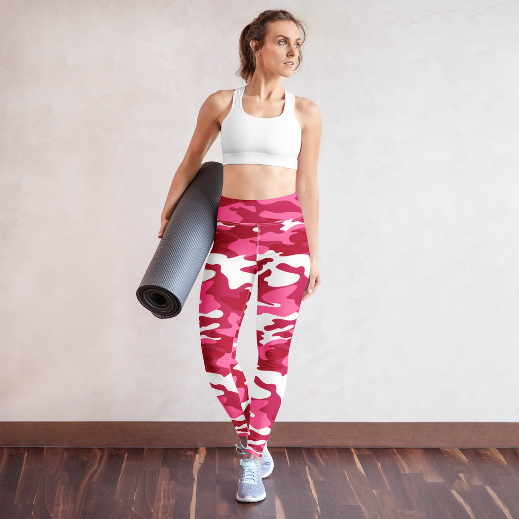 A woman wearing womens pink camouflage buttery soft high waisted leggings with a white sports bra for yoga