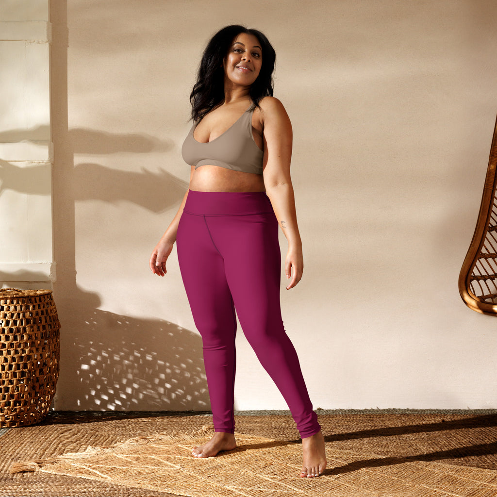 A pair of dark magenta high-waisted buttery soft yoga leggings made from stretchy form-fitting fabric