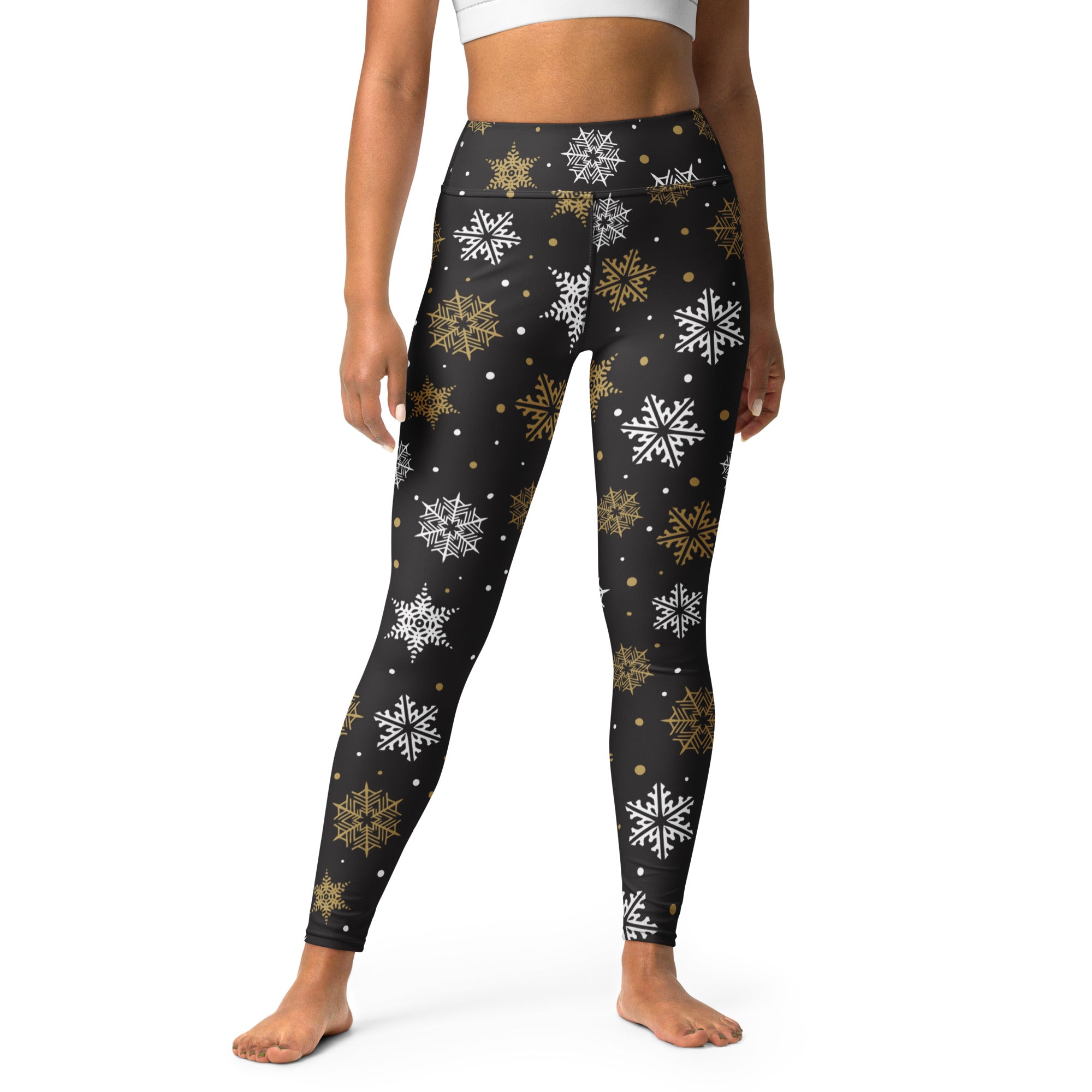 Black high-waisted buttery soft yoga leggings with gold and white snowflake festive pattern for women