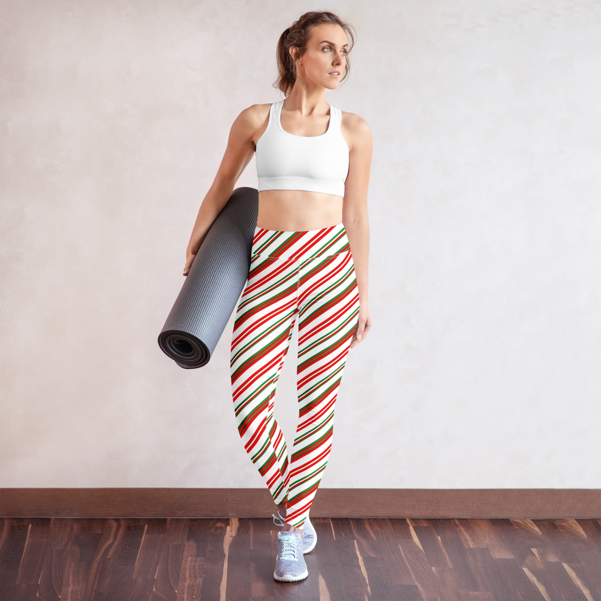 Woman wearing festive red green and white striped buttery soft cotton yoga leggings for women