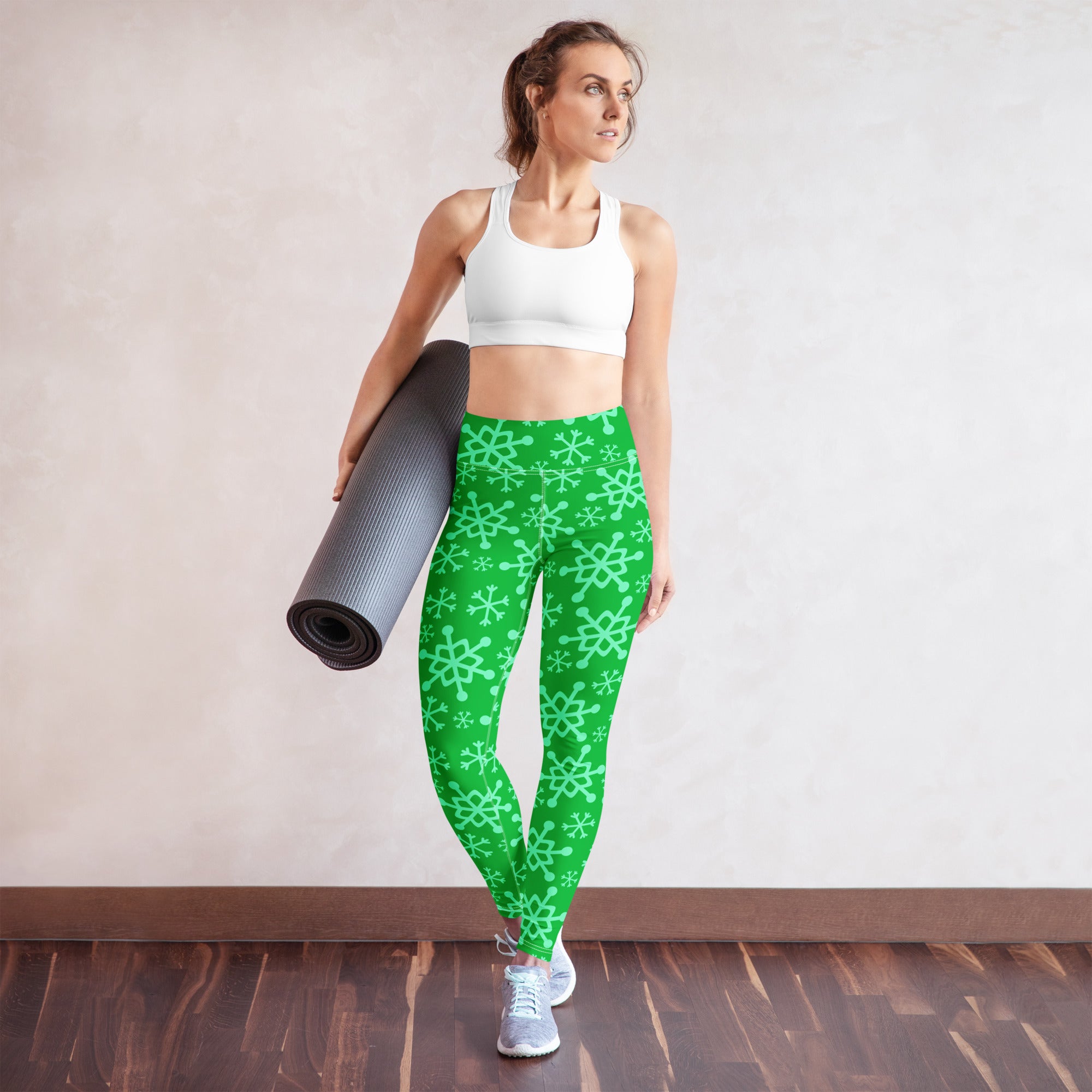 Women’s green snowflake buttery soft yoga leggings with light green snowflake patterns and stretchy fabric