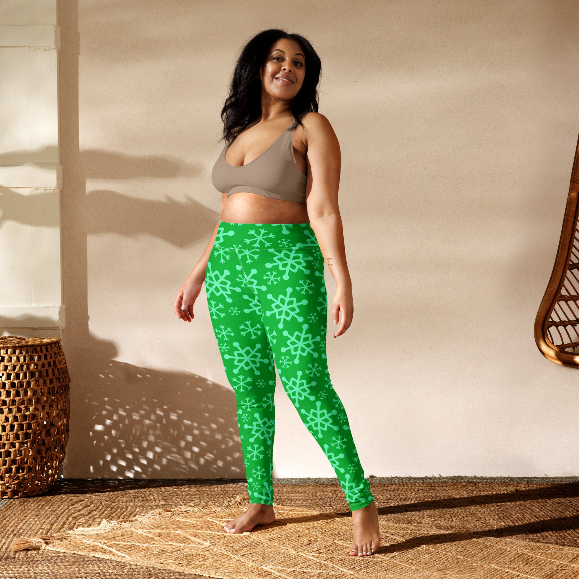 Women’s green buttery soft yoga leggings with bright green color and light teal snowflake pattern
