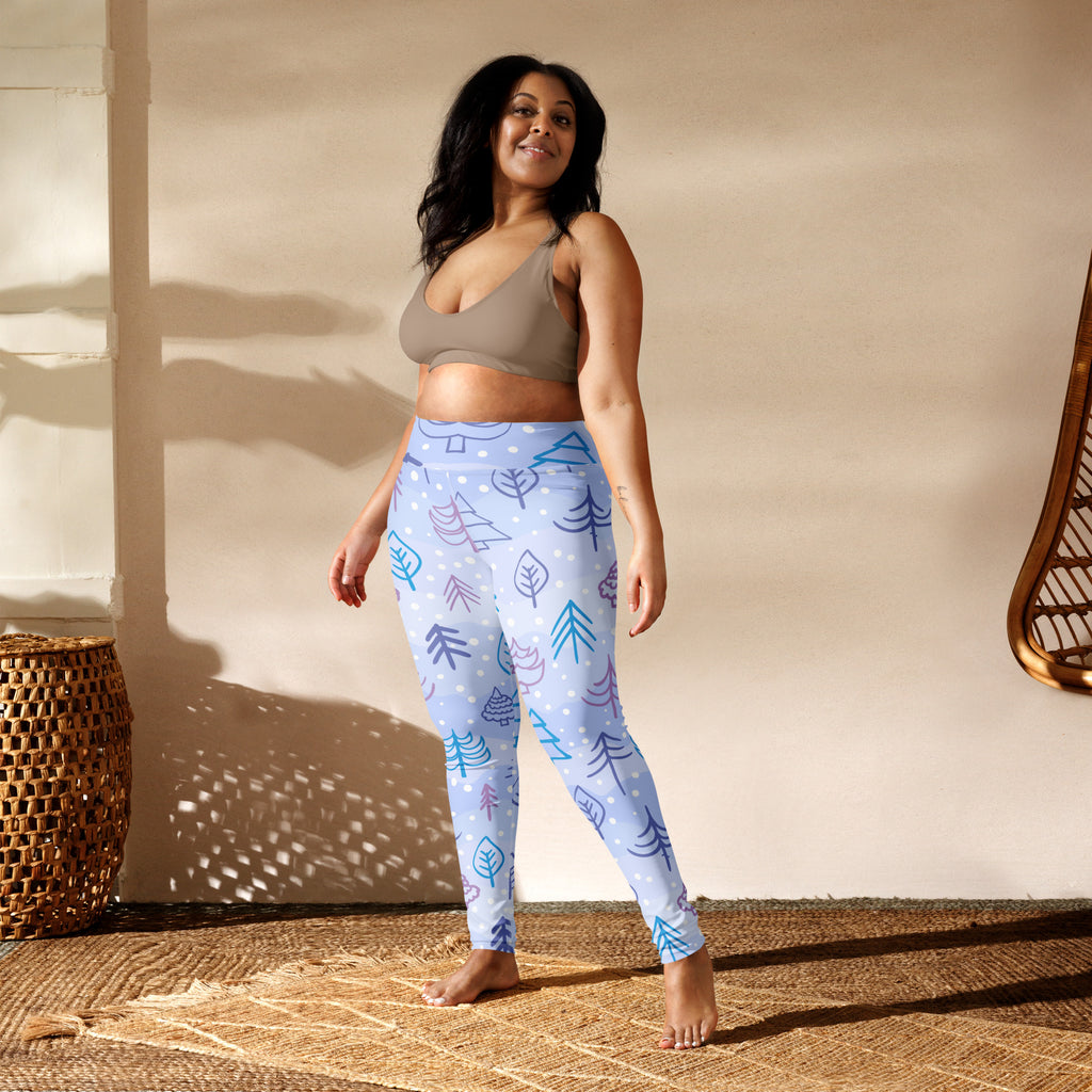 Women’s winter themed buttery soft yoga leggings in light blue with teal purple and white tree and leaf patterns
