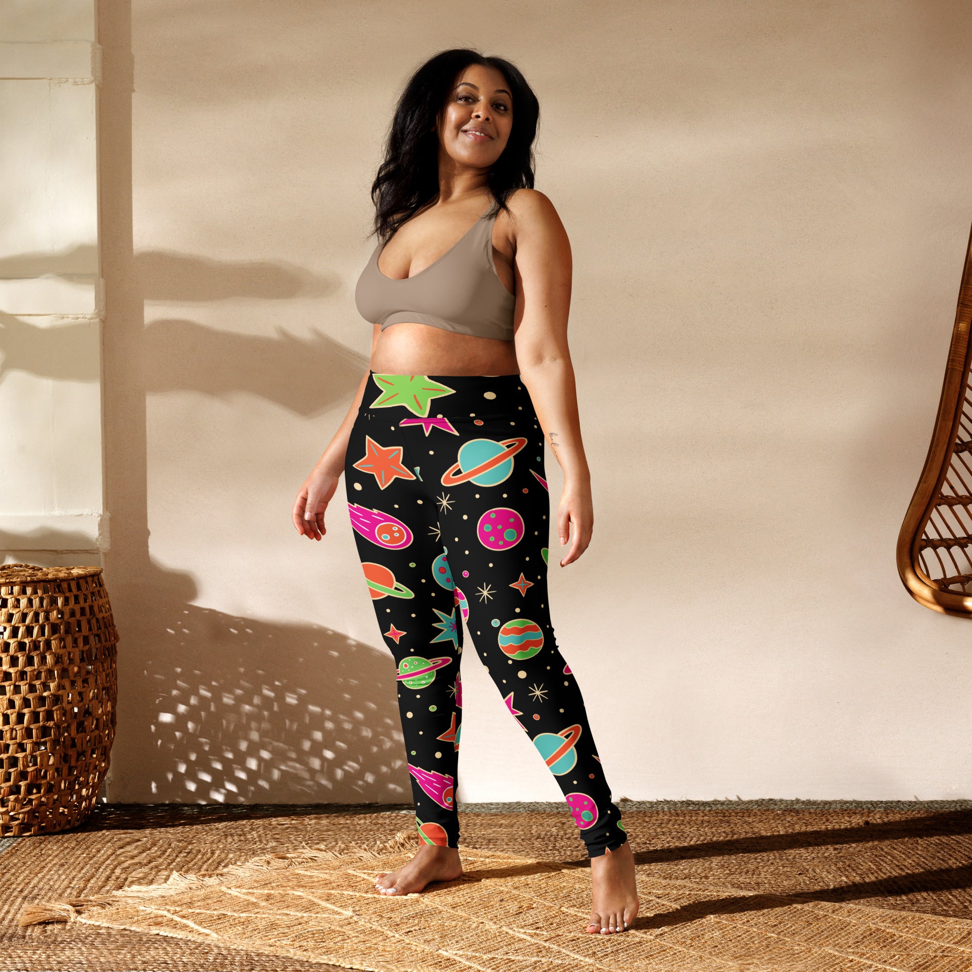 Black womens buttery soft yoga leggings with neon pink green orange and blue space planets stars and comets design