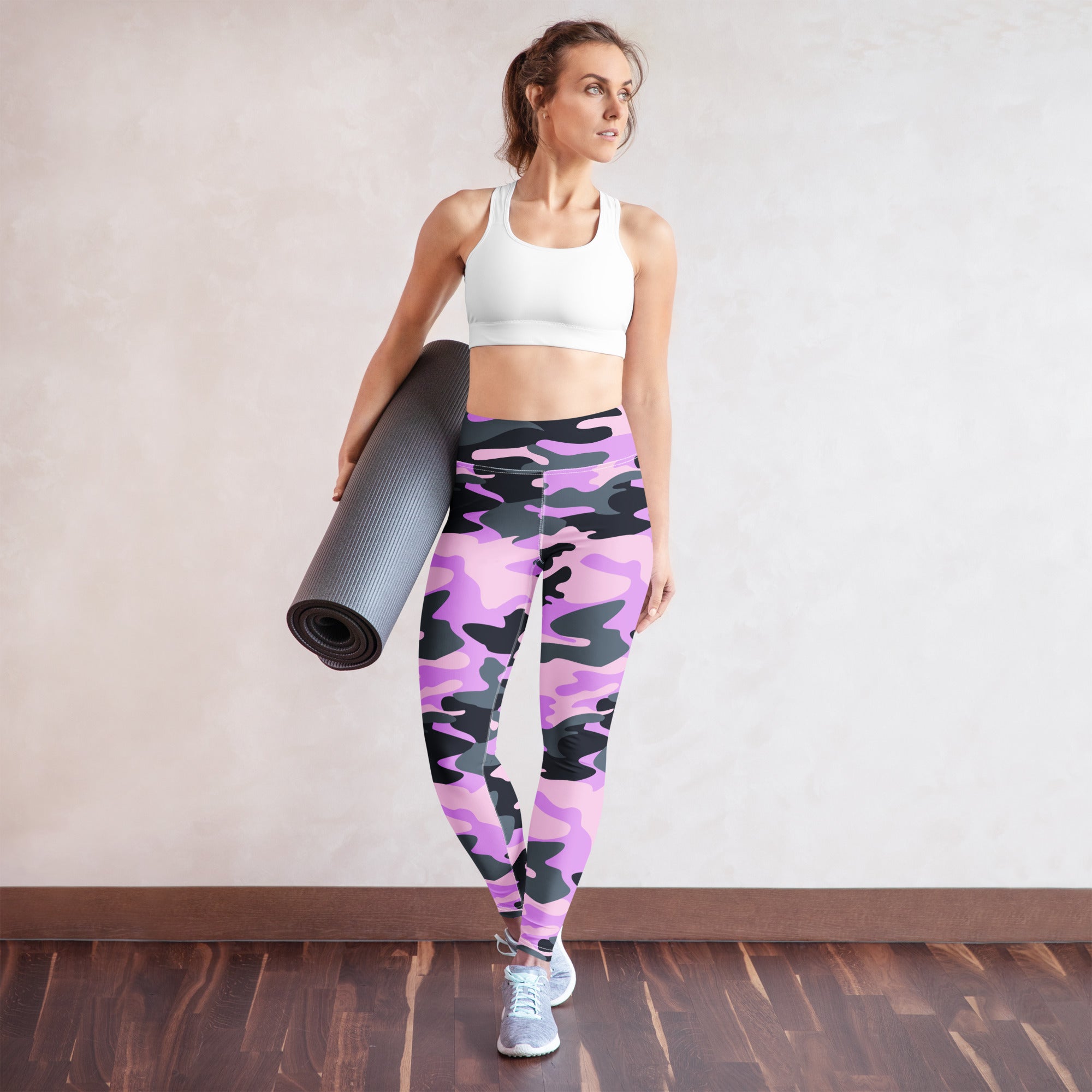 Woman wearing purple and black camouflage buttery soft yoga leggings showing the back side