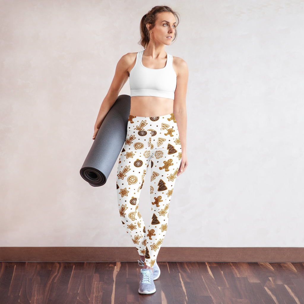 White buttery soft yoga leggings with festive gingerbread cookies stars and trees pattern in gold and brown tones
