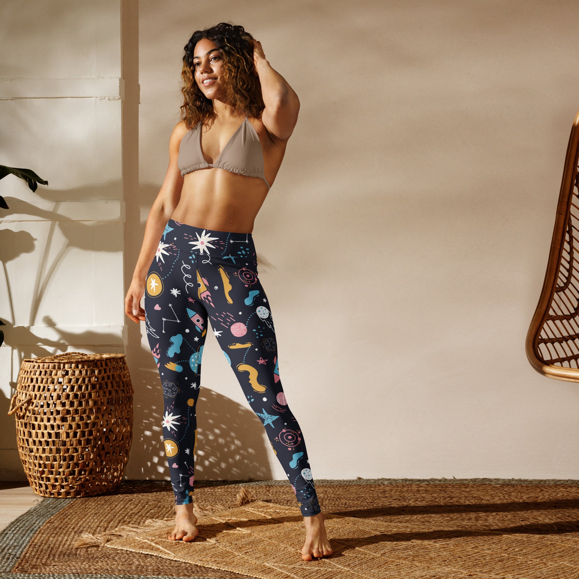 Women’s outer space buttery soft yoga leggings in dark blue with colorful stars planets rockets and cosmic illustrations
