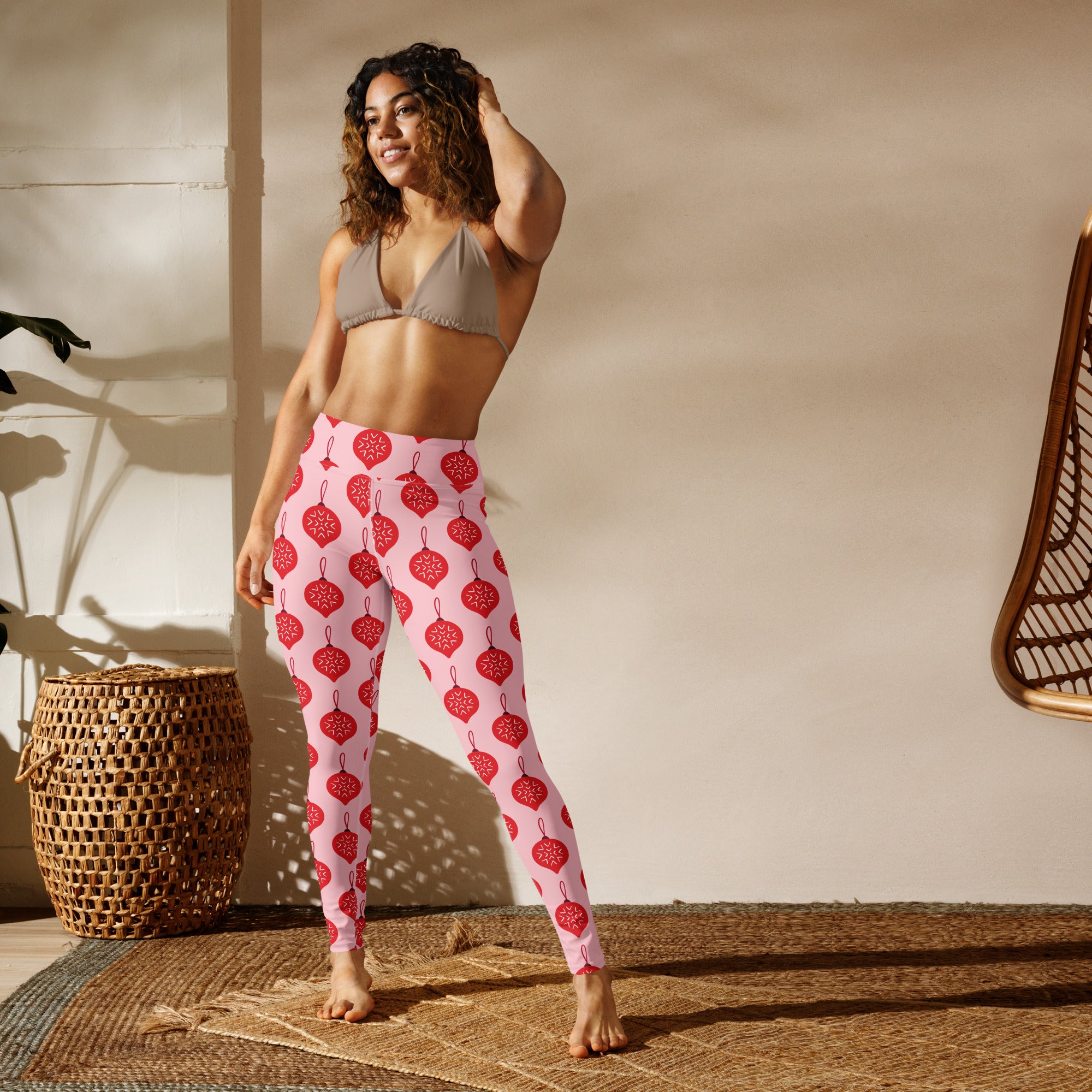 Women’s pink buttery soft yoga leggings with red christmas ornaments and white snowflake pattern
