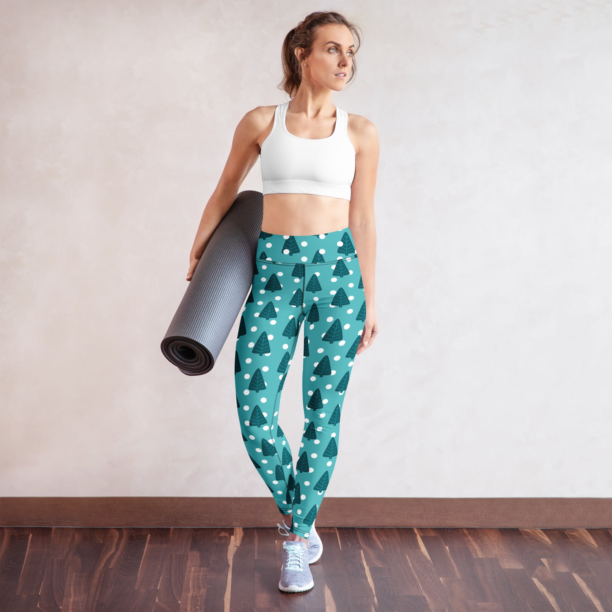 Women’s teal buttery soft yoga leggings with dark green pine tree pattern and white polka dots for winter wear