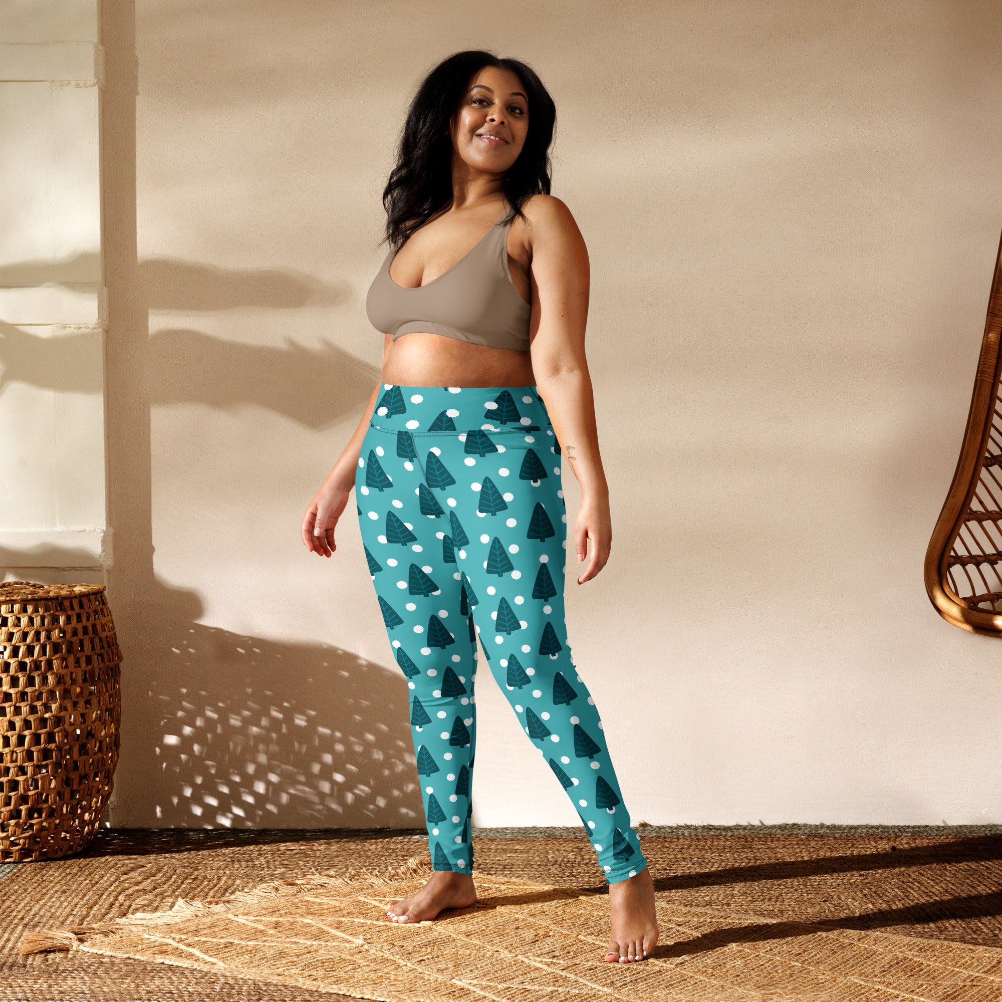 Women’s teal buttery soft yoga leggings with dark green pine tree pattern and white polka dots for winter wear