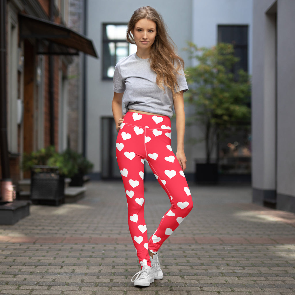 Women’s bright pink high waisted yoga leggings with red and white heart pattern on buttery soft stretchy fabric