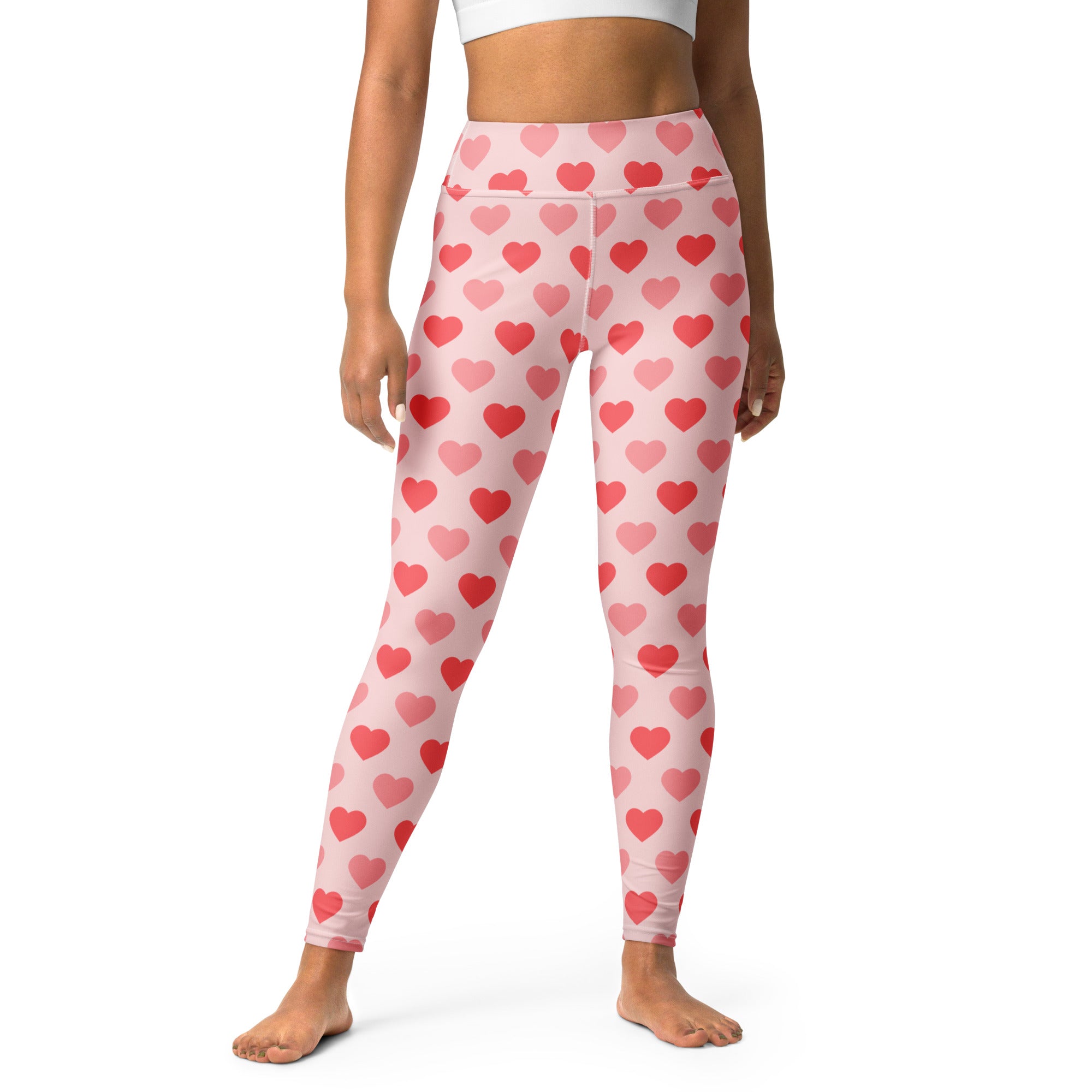 Women’s pink high-waisted heart-patterned yoga leggings made of buttery soft quick-drying fabric