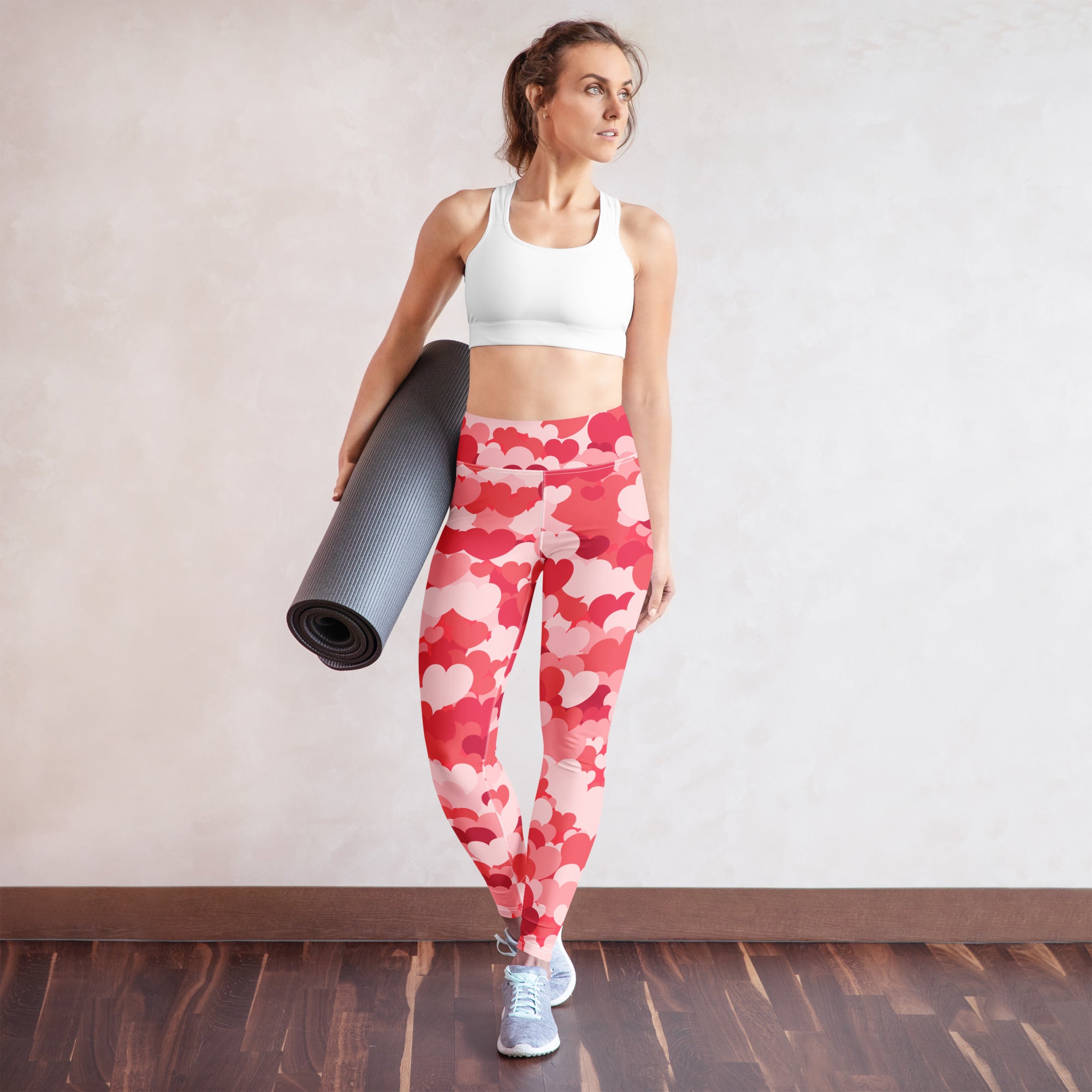 Woman wearing women’s pink heart clouds buttery soft high waisted red and pink heart-patterned yoga leggings